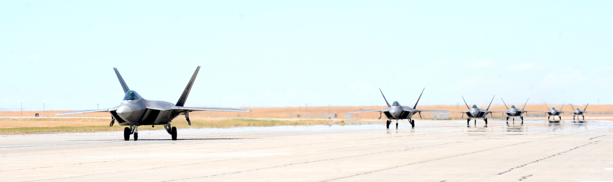 MOUNTAIN HOME AIR FORCE BASE, Idaho -- A group of F-22 Raptors from the 43rd Fighter Squadron out of Tyndall AFB, Fla., land here July 29. More than 150 Airmen and 12 F-22 Raptors from the 43rd Fighter Squadron, Tyndall Air Force Base, Fla., arrived here in support of the Air Force’s first Operation Global Gem joint multi-service training. Global Gem is being conducted here from Aug. 2 to Sept. 2 and is primarily focused on conducting F-22 Raptor training missions with Marine F-5s and Air Force F-15Es. (U.S. Air Force photo by Airman 1st Class Debbie Lockhart)