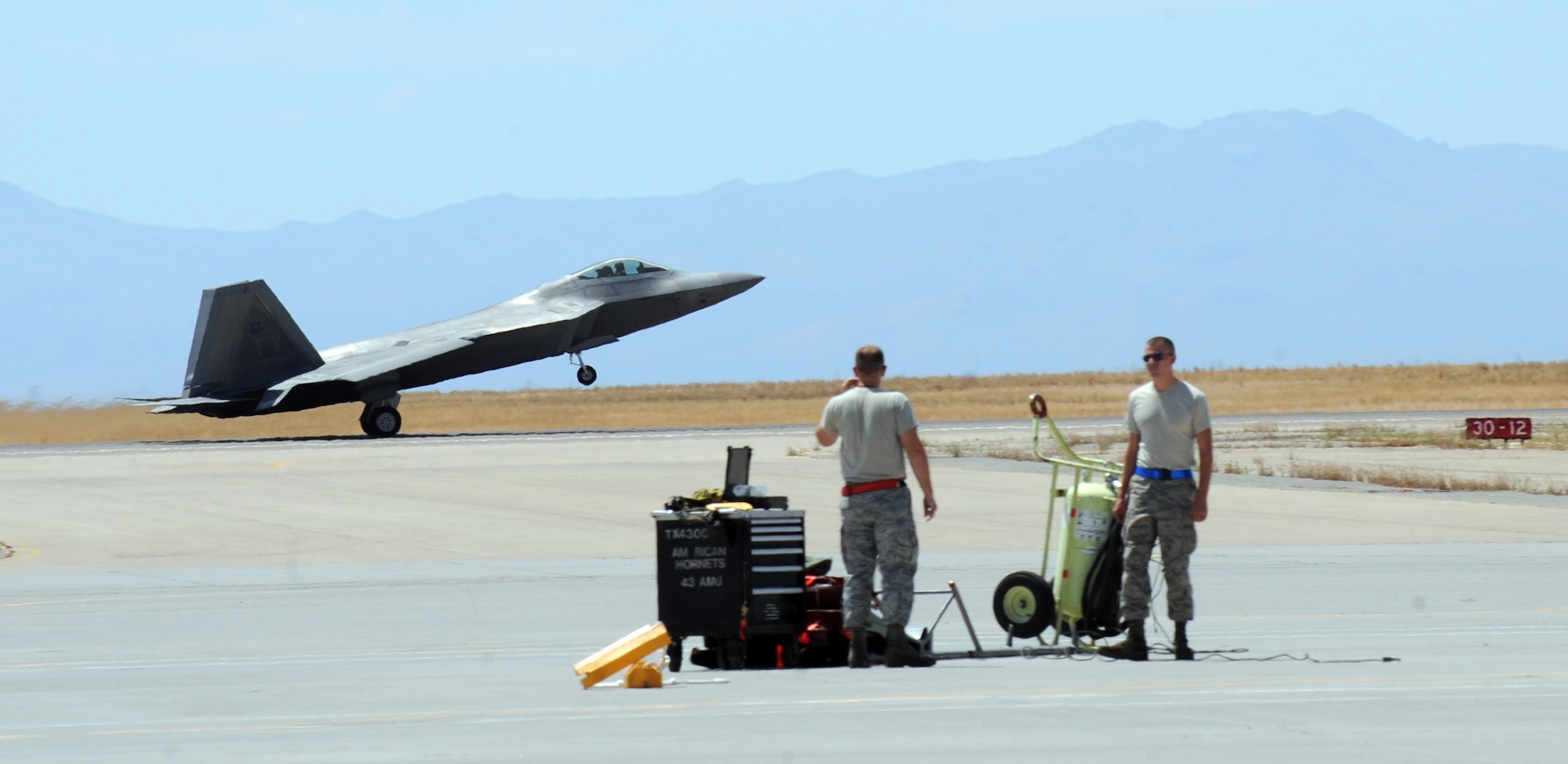 MOUNTAIN HOME AIR FORCE BASE, Idaho -- Crew chiefs from the 43rd Aircraft Maintenance Unit out of Tyndall AFB, Fla., prepare to receive an F-22 Raptor after its landing July 29. More than 150 Airmen and 12 F-22 Raptors from the 43rd Fighter Squadron, Tyndall Air Force Base, Fla., arrived in support of the Air Force’s first Operation Global Gem joint multi-service training. Global Gem is being conducted here from Aug. 2 to Sept. 2 and is primarily focused on conducting F-22 Raptor training missions Marine F-5s and Air Force F-15Es. (U.S. Air Force photo by Airman 1st Class Debbie Lockhart)