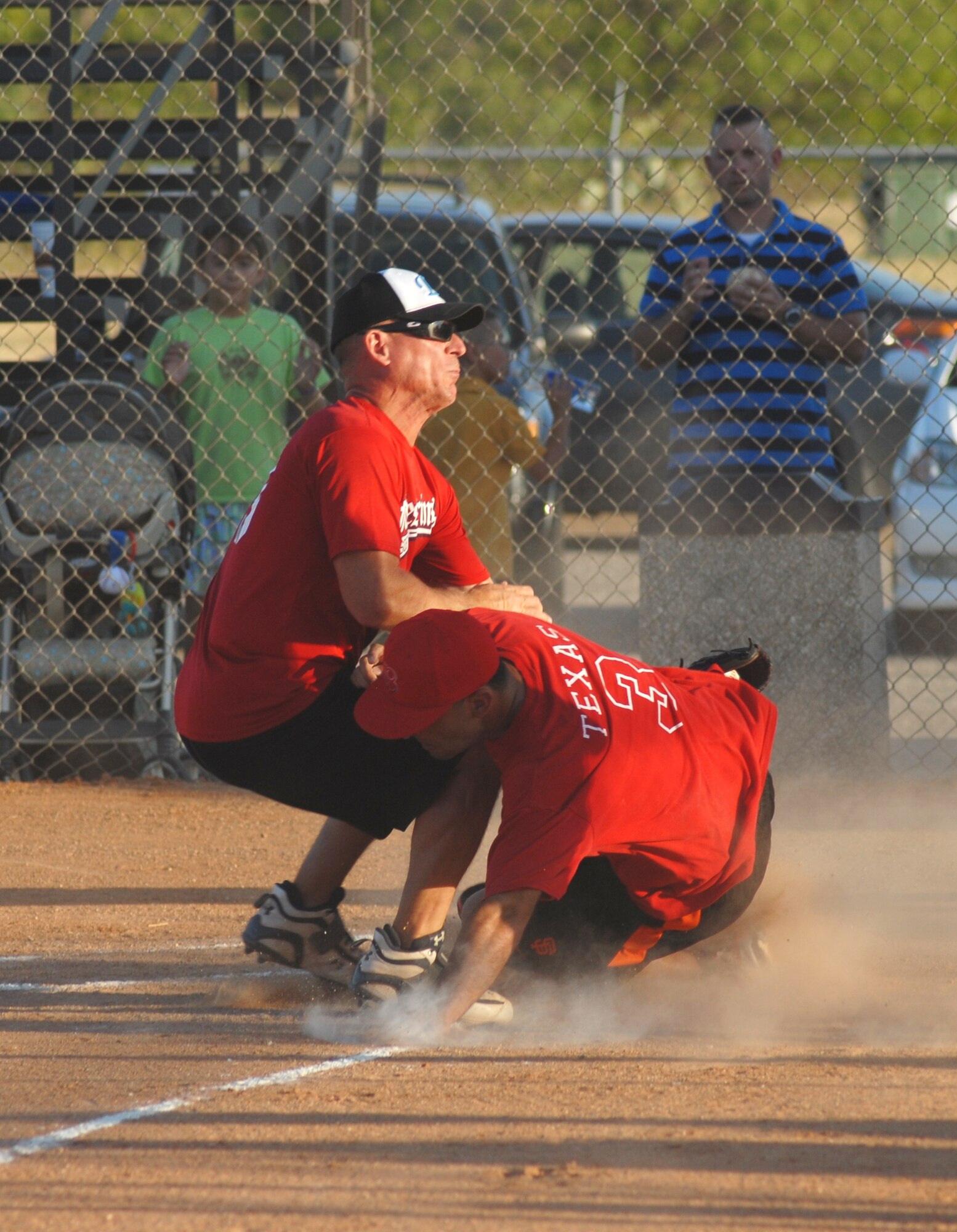 17th Mission Support Group pitcher Charlie Rehburg runs home and tags Ryan Norton, 315th Training Squadron, out during the 2010 Intramural Softball championship game between the 315 TRS and 17 MSG. After a doubleheader, 17 MSG defeated 315 TRS, 15-12, taking the base championship. (U.S. Air Force photo/Connie Hempel)