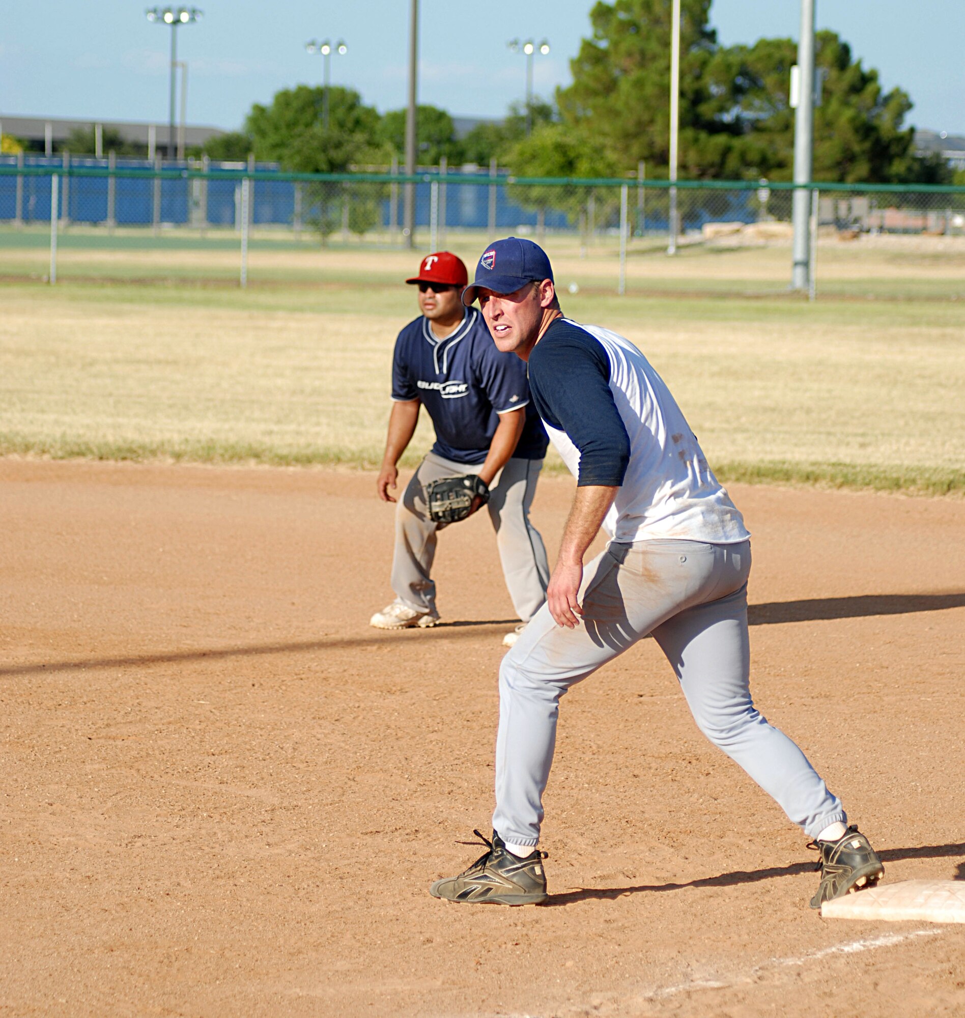 Chris LeRoy, 315th Training Squadron, prepares to make his move to second, while 17th Mission Support Group first baseman Omar Matos, waits to make a play during the 2010 Intramural Softball championship game Aug. 4. After a doubleheader, 17 MSG defeated 315 TRS, 15-12, taking the base championship. (U.S. Air Force photo/Connie Hempel)