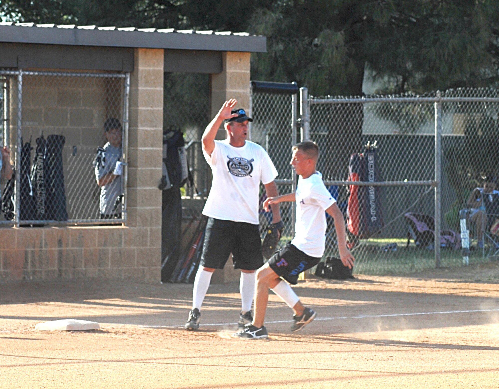 17th Mission Support Group third baseman James Fountain calls for the pass while Brad Bell, 315th Training Squadron, makes for third during the 2010 Intramural Softball championship game between the 315 TRS and 17 MSG Aug. 4. After a doubleheader, 17 MSG defeated 315 TRS, 15-12, taking the base championship. (U.S. Air Force photo/Connie Hempel)