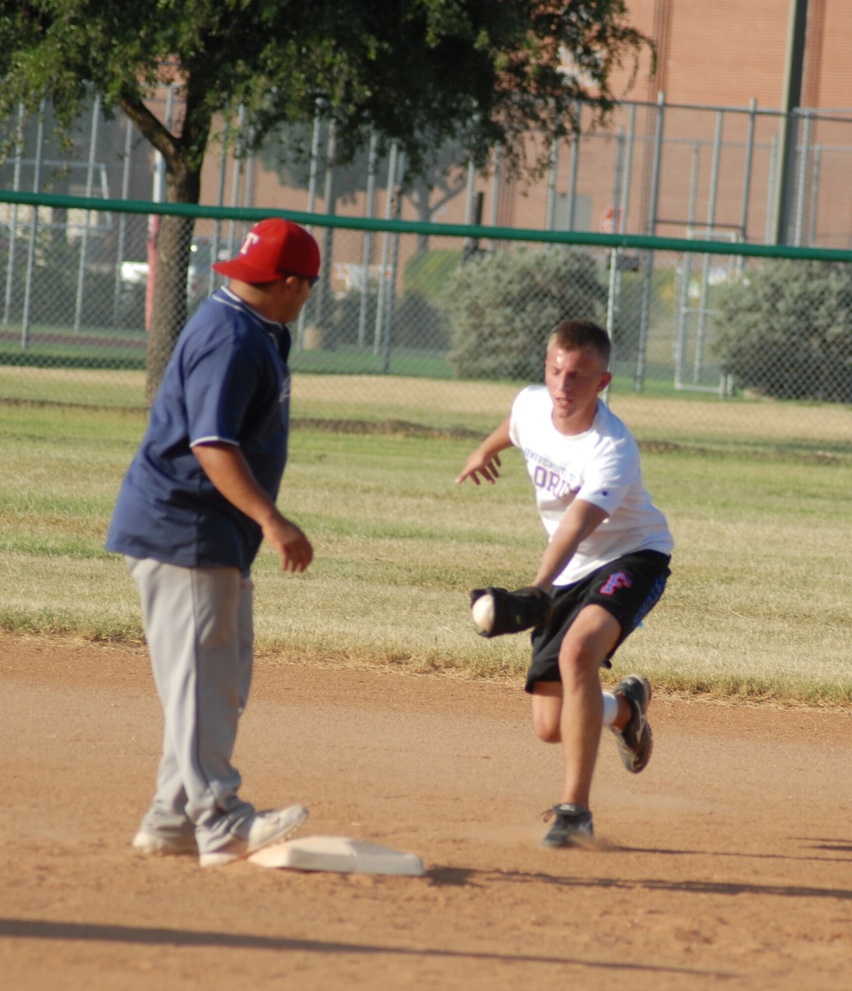 Omar Matos, 17th Mission Support Group, makes it safely back to second before 315th Training Squadron second baseman Brad Bell could tag him during the 2010 Intramural Softball championship game Aug. 4. After a doubleheader, 17 MSG defeated 315 TRS, 15-12, taking the base championship. (U.S. Air Force photo/Connie Hempel)