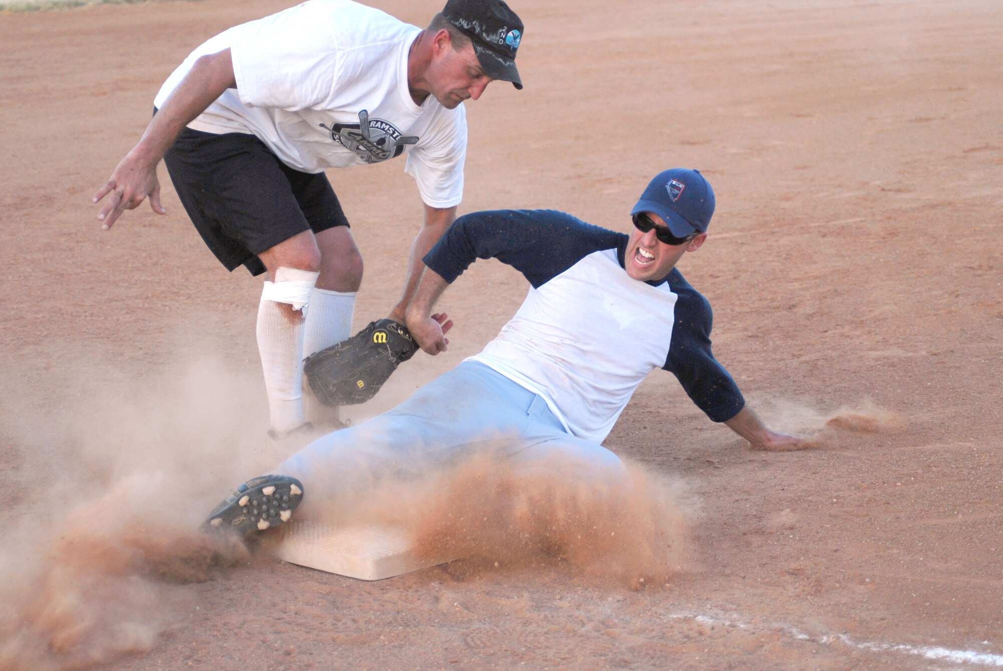 Chris LeRoy, 315th Training Squadron, makes third before James Fountain, 17th Mission Support Group, could tag him out during the 2010 Intramural Softball championship game Aug. 4. After a doubleheader, 17 MSG defeated 315 TRS, 17-11, taking the base championship. (U.S. Air Force photo/Connie Hempel)