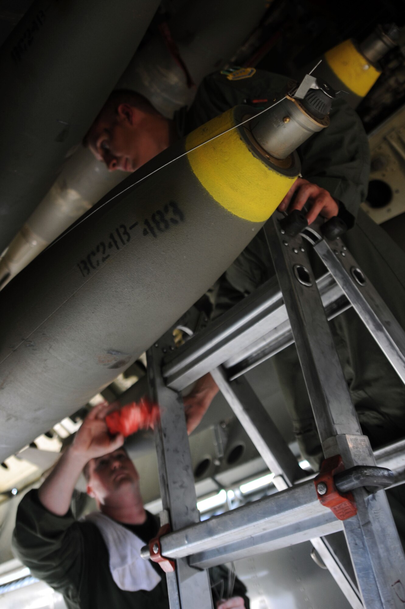 BARKSDALE AIR FORCE BASE, La. -- Capt. Ryan Allen, 20th Bomb Squadron radar navigator, pulls the safety pin from a weapon during the Bucc Smoke competition Aug. 3. Flights will be held in the 60th Utah Test and Training Range and the Nevada Test and Training Range. The final score will be determined through a compilation of commit criteria, test scores, bomb scores and commander's input. (U.S. Air Force photo by Senior Airman Brittany Y. Bateman)(RELEASED)
