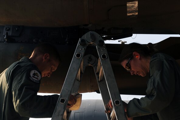 BARKSDALE AIR FORCE BASE, La. -- Capt. Jamie Denton, 20th Bomb Squadron aircraft commander, and Capt. Ryan Allen, 20th BS radar navigator, climb down a ladder after checking a weapon on a B-52H Stratofortress during the Bucc Smoke competition Aug. 3.  Each flight crew is evaluated on their tactical plan and execution. (U.S. Air Force photo by Senior Airman Brittany Y. Bateman)(RELEASED)