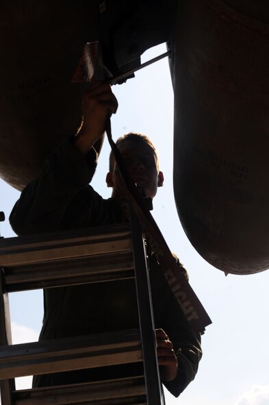 BARKSDALE AIR FORCE BASE, La. -- Capt. Ryan Allen, 20th Bomb Squadron radar navigator, pulls the safety pin from a weapon during the Bucc Smoke competition Aug. 3. Flights will be held in the 60th Utah Test and Training Range and the Nevada Test and Training Range. The final score will be determined through a compilation of commit criteria, test scores, bomb scores and commander's input. (U.S. Air Force photo by Senior Airman Brittany Y. Bateman)(RELEASED)