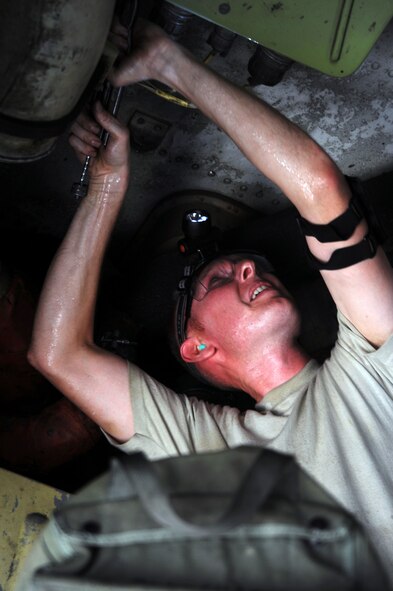 BARKSDALE AIR FORCE BASE, La. -- Tech. Sgt. Thomas Richey, 20th Aircraft Maintenance Unit weapons load team chief, performs pre-flight maintenance to a B-52H Stratofortress during the Bucc Smoke competition Aug. 3.  Bucc Smoke will foster esprit de corp among the squadron while giving the 20th Bomb Squadron chance to hone its tactical edge.  (U.S. Air Force photo by Senior Airman Brittany Y. Bateman)(RELEASED)
