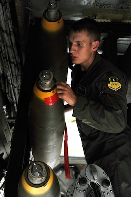 BARKSDALE AIR FORCE BASE, La. -- Capt. Ryan Allen, 20th Bomb Squadron radar navigator, does a pre-flight check on a weapon during the Bucc Smoke competition Aug. 3. The 20th BS weapons and tactics, scheduling and training flights have worked closely to plan, schedule and design the tactical objectives for the competition. (U.S. Air Force photo by Senior Airman Brittany Y. Bateman)(RELEASED)

