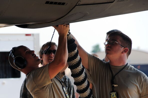 BARKSDALE AIR FORCE BASE, La. -- Airmen from the 20th Aircraft Maintenance Unit, attach an air cart to a B-52H Stratofortress during the Bucc Smoke competition Aug. 3. In order to do well in the competition, members of the 20th Bomb Squadron are required to integrate with various joint players in the mission planning phase. (U.S. Air Force photo by Senior Airman Brittany Y. Bateman)(RELEASED)