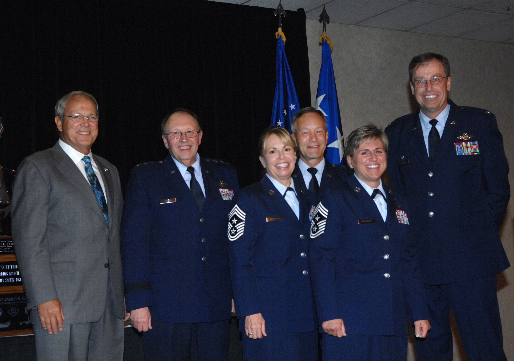 From left:  Maj. Gen. (ret) Richard Roth, Greater Riverside Chambers of Commerce; Lt. Gen. Charles Stenner, Commander, Air Force Reserve Command; Chief Master Sgt. Patricia Thornton, Command Chief, Headquarters 4th Air Force; Maj. Gen. Eric Crabtree, Commander, HQ AF; CMSgt. Peri Rogowski, Command Chief, 445th Airlift Wing, Wright-Patterson Air Force Base, Ohio; and Col. Stephen Goeman, Commander, 445 AW, pose for the cameras after the wing was awarded the Raincross Trophy July 22, in Riverside, Calif.  The award is given to the best wing in 4th Air Force.  (U.S. Air Force photo/Tech. Sgt. Meredith Mingledorff)
