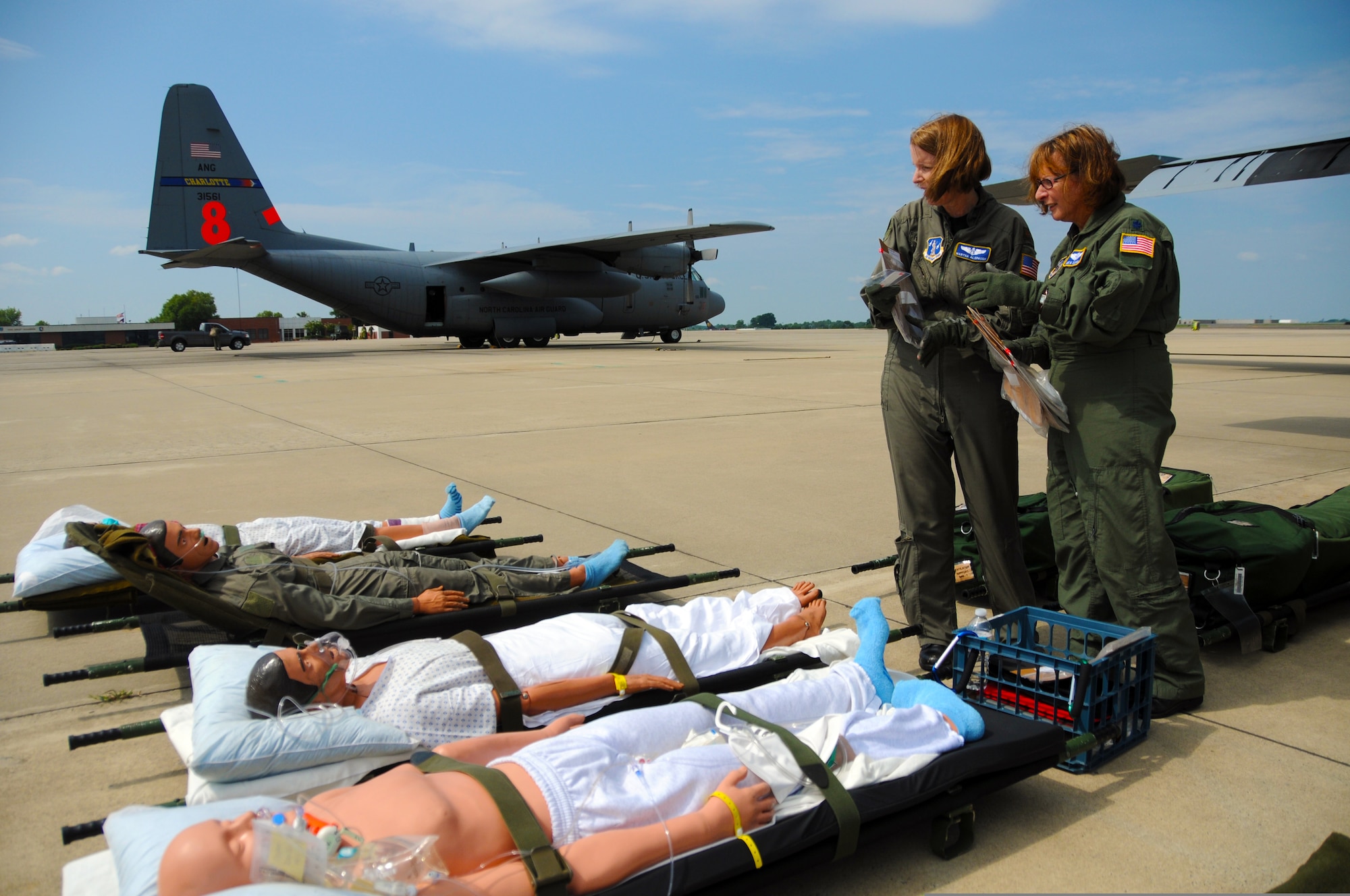 U.S. Air Force Maj. Martha Alspaugh, left, and Lt. Col. Jane Elkovich, both flight nurses assigned to 156th Aeromedical Evacuation Squadron, North Carolina Air National Guard, prepare dummies before loading them into a C-130 Hercules aircraft in Charlotte, N.C., July 29, 2010, for a check ride. The Airmen are hosting Moldovan military medical officers while sharing the North Carolina National Guard?s medical evacuation techniques. The exchange is part of the NATO State Partnership Program, which links U.S. states with partner countries for the purpose of supporting U.S. security cooperation objectives. (DoD photo by Tech. Sgt. Brian E. Christiansen, U.S. Air Force/Released)