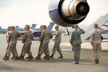 31 July 2010  USAF Photo by Jason Minto.  A U.S. Marine Corps carry team transfers the remains of Marine LCpl Shane R. Martin of Spring, TX., at Dover Air Force Base, Del., July 31, 2010.  
