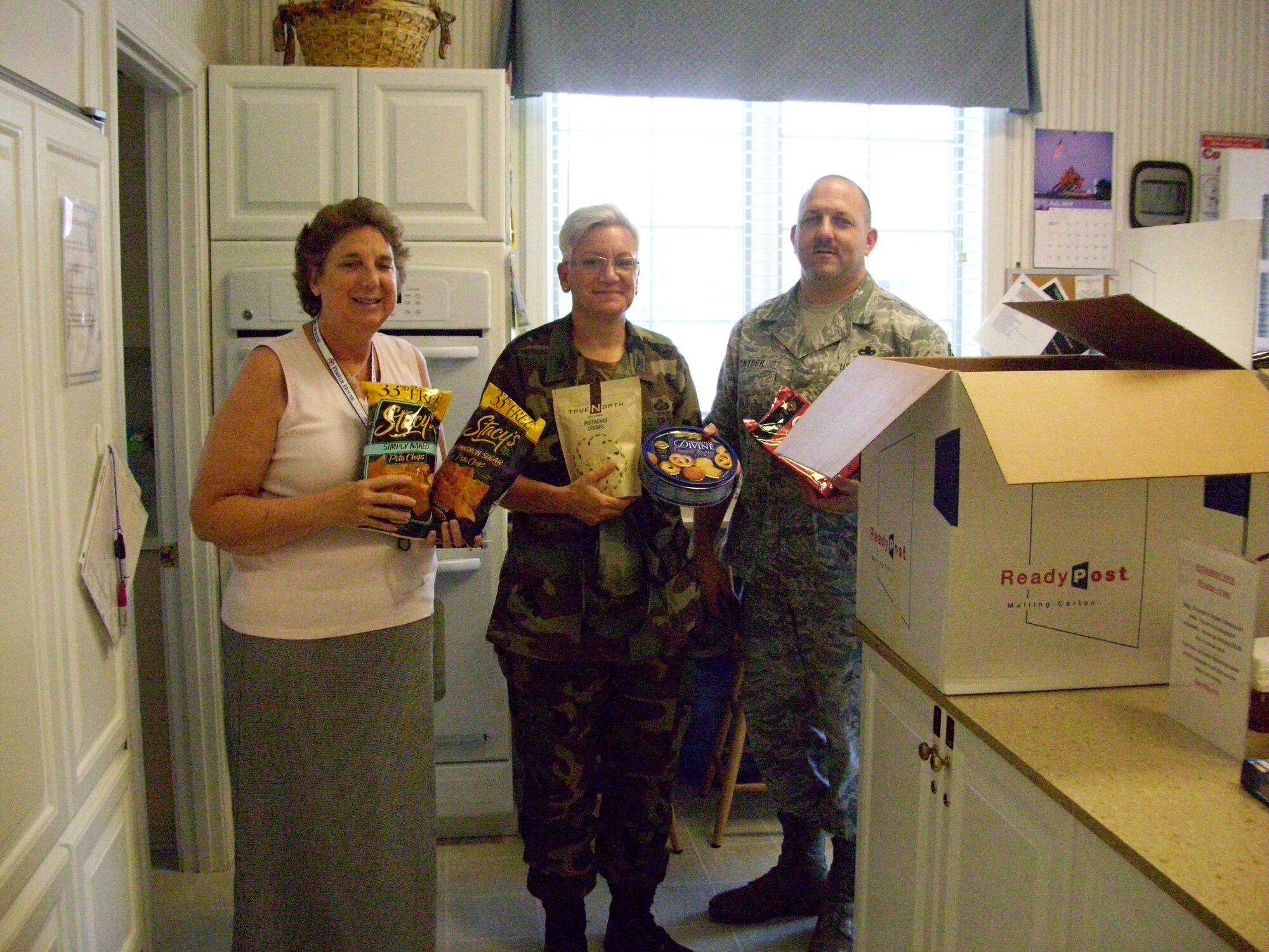 WRIGHT-PATTERSON AIR FORCE BASE, Ohio – Col. Anna Schulte, 445th Maintenance Group commander, and Senior Master Sgt. Monte Snyder, 445th Maintenance Operations Flight, deliver more than 105 pounds of food items to Karen Healea, Fisher/Nightingale House manager that was collected by volunteers from the 445th MXG July 30. The Fisher/Nightingale house provides physical and emotional support to servicemembers by providing an opportunity for military families to stay together and support each other when a loved one is undergoing medical treatment. (Courtesy photo)