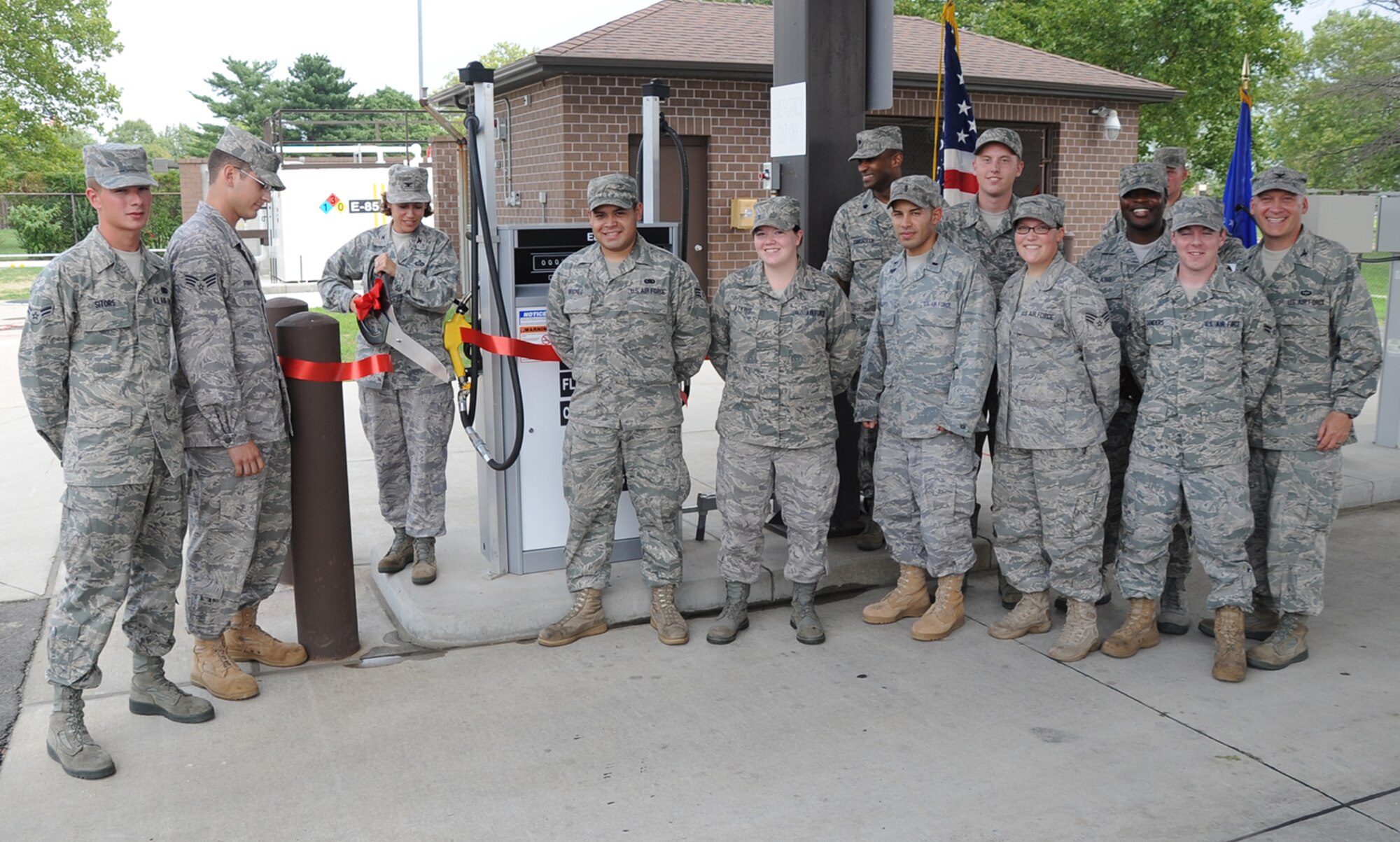 Joint Base McGuire-Dix-Lakehurst commander Col. Gina Grosso cuts a ribbon, officially opening the base's new E85 fuel tank. The fuel will be used in flex-fuel government vehicles as part of the installation's efforts to reduce carbon emissions. (U.S. Air Force photo/ Airman 1st Class Bryan Swink)