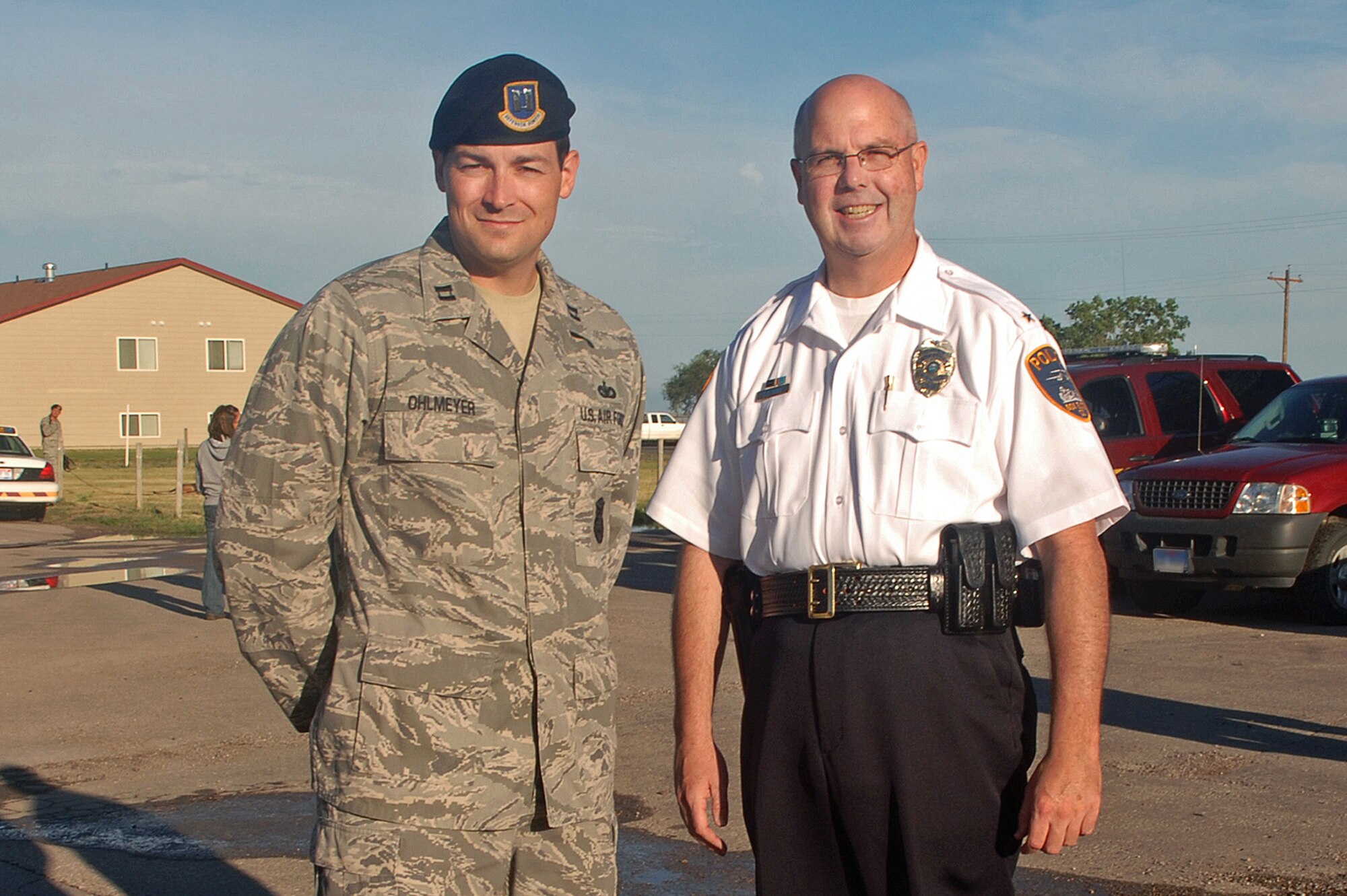 ELLSWORTH AIR FORCE BASE S.D. – Capt. Steven Ohlmeyer, 28th Security Forces Squadron commander, and Chief Tim Ryan, Box Elder police chief, stand side by side at Box Elder’s National Night Out event, Aug. 3.  NNO is a campaign headed by law enforcement agencies across the United States to help prevent crime.  (U.S. Air Force photo/Airman 1st Class Alessandra N. Hurley)