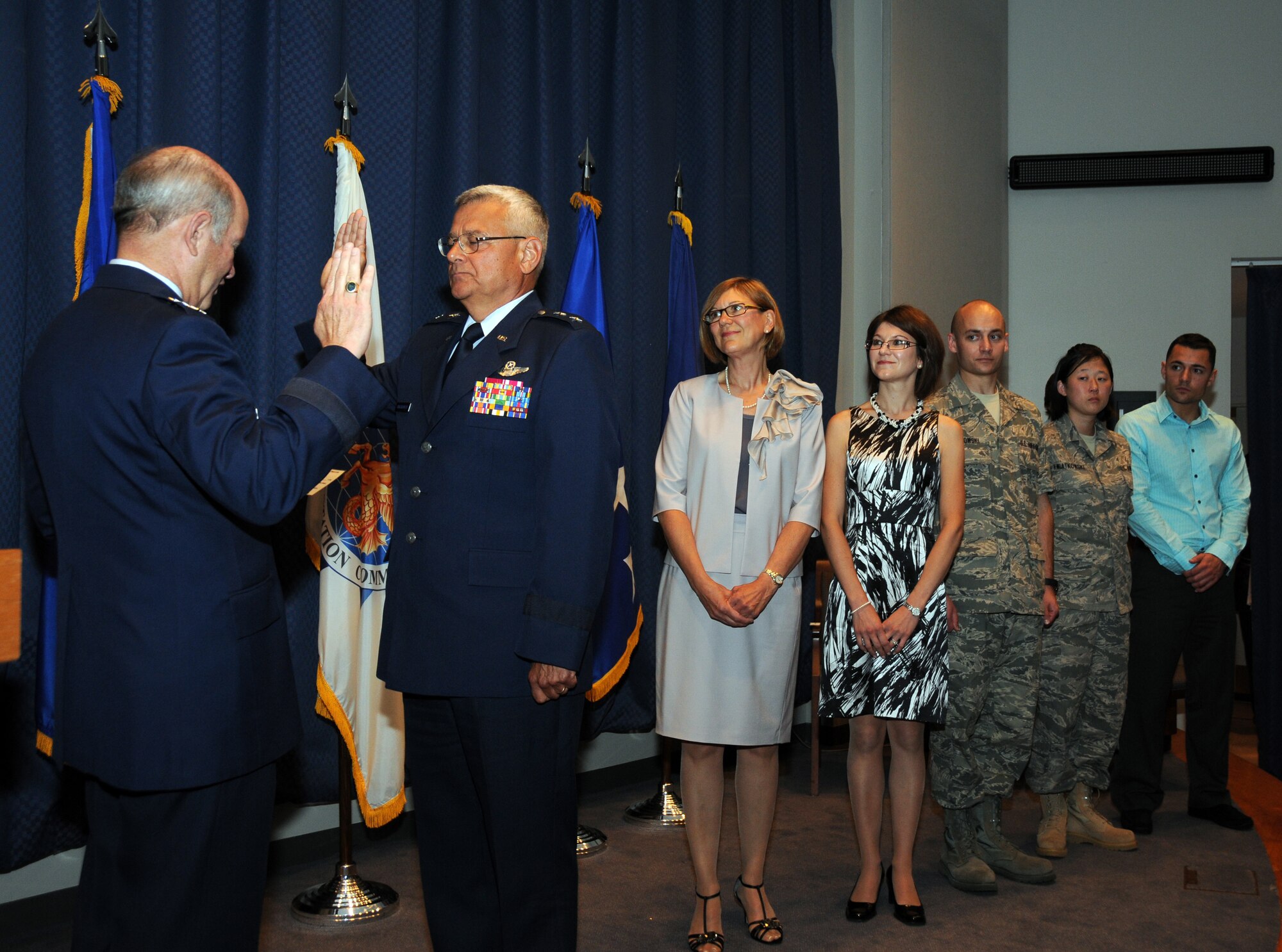 General Duncan McNabb, Commander, United States Transportation Command  administers the Officers Oath to newly promoted Maj. Gen. James Kwiatkowski, as the major general's family looks on. (Front to back) his wife Ranea Kwiatkowski, his daughter Nichole Dabby, his son 107th AW member Tech. Sgt. Andrew Kwiatkowski, his daughter 107th AW member Airman 1st Class Laura Kwiatkowski and his son Kevin Kwiatkowski. (U.S. Air Force photo/Staff Sgt. Peter Dean)