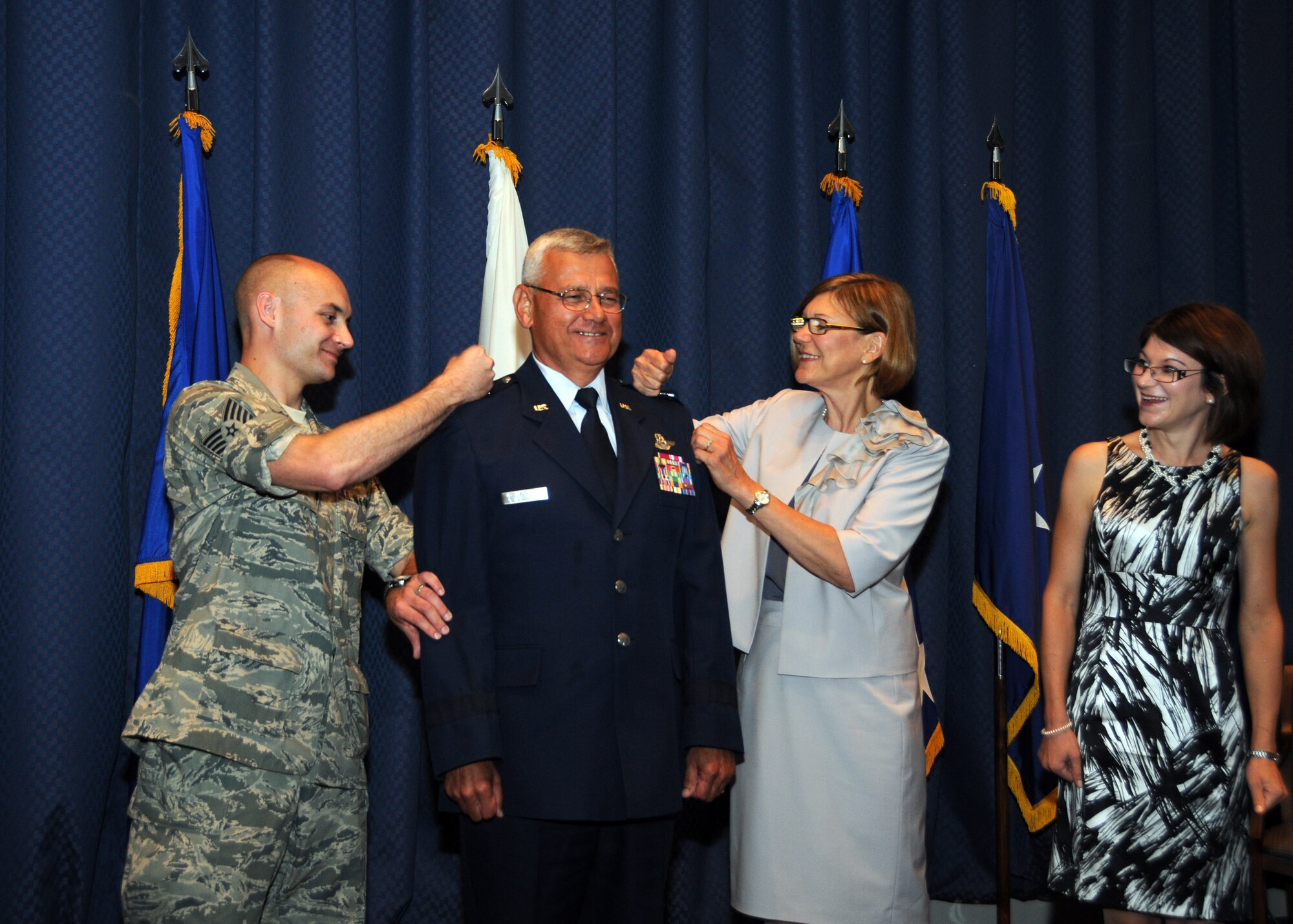 Maj. Gen. James Kwiatkowski is pinned by his son 107th AW Tech. Sgt. Andrew Kwiatkowski and the general's wife Ranea on right as his other daughter Nicole Dabby looks on during a ceremony held Aug. 4 at Scott AFB. "This is a sacred trust and I will do my best to be effective in the trust placed in me today," said the general. (U.S. Air Force photo/Staff Sgt. Peter Dean)