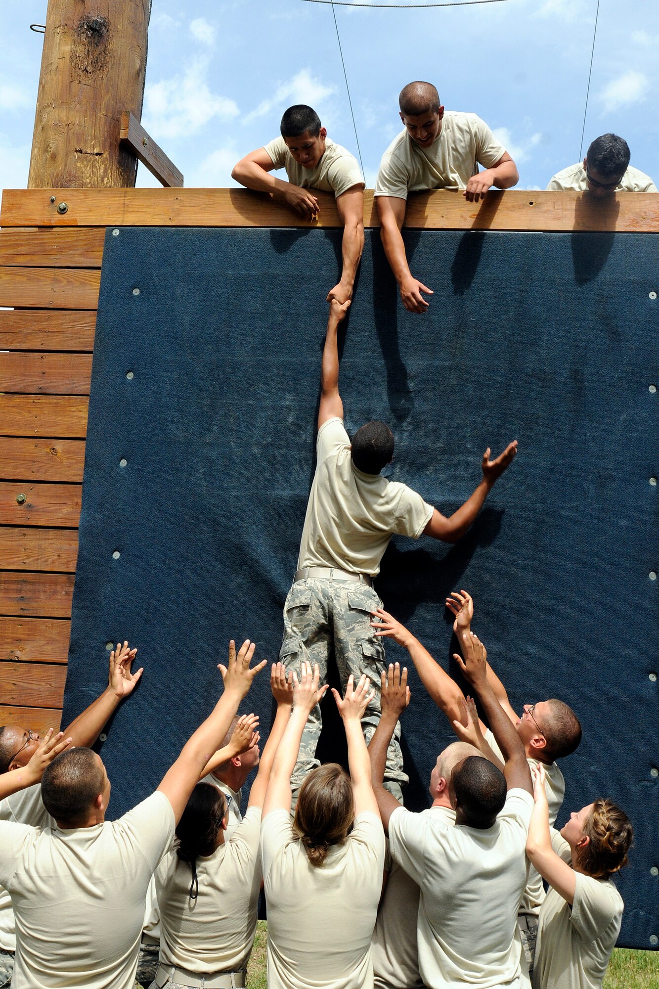 Air Force Academy Preparatory School cadet candidates help one of their own scale an obstacle at the Academy's Ropes Course July 31, 2010. The course is designed to build esprit de corps among team members as they cooperatively navigate obstacles. (U.S. Air Force photo/J. Rachel Spencer)