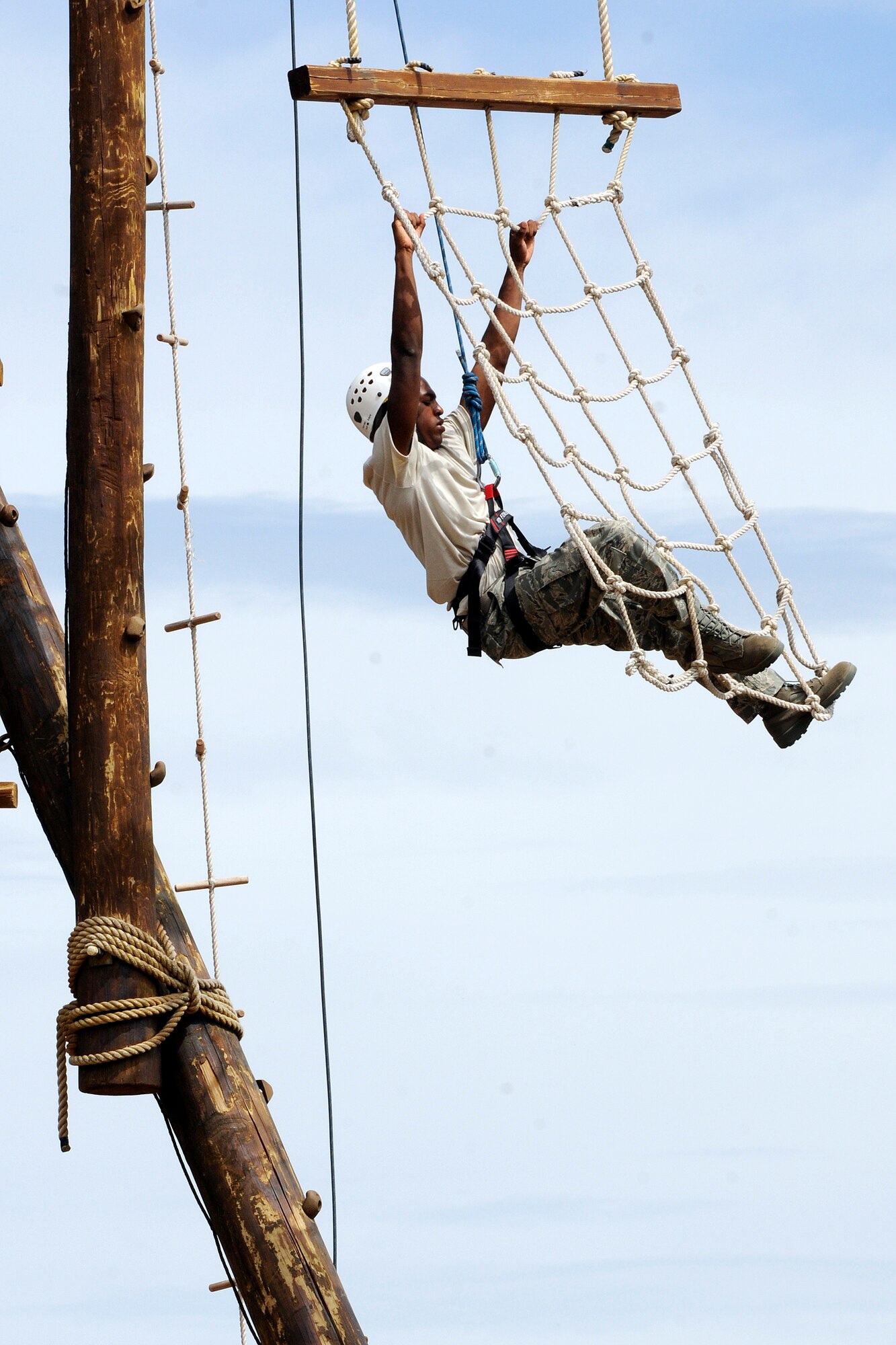 A cadet candidate with the Air Force Academy Preparatory School pulls himself up the Academy's Ropes Course July 23, 2010. Prep School students receive military, academic and time-management training to prepare them for their freshmen years at the Academy. (U.S. Air Force photo/J. Rachel Spencer)