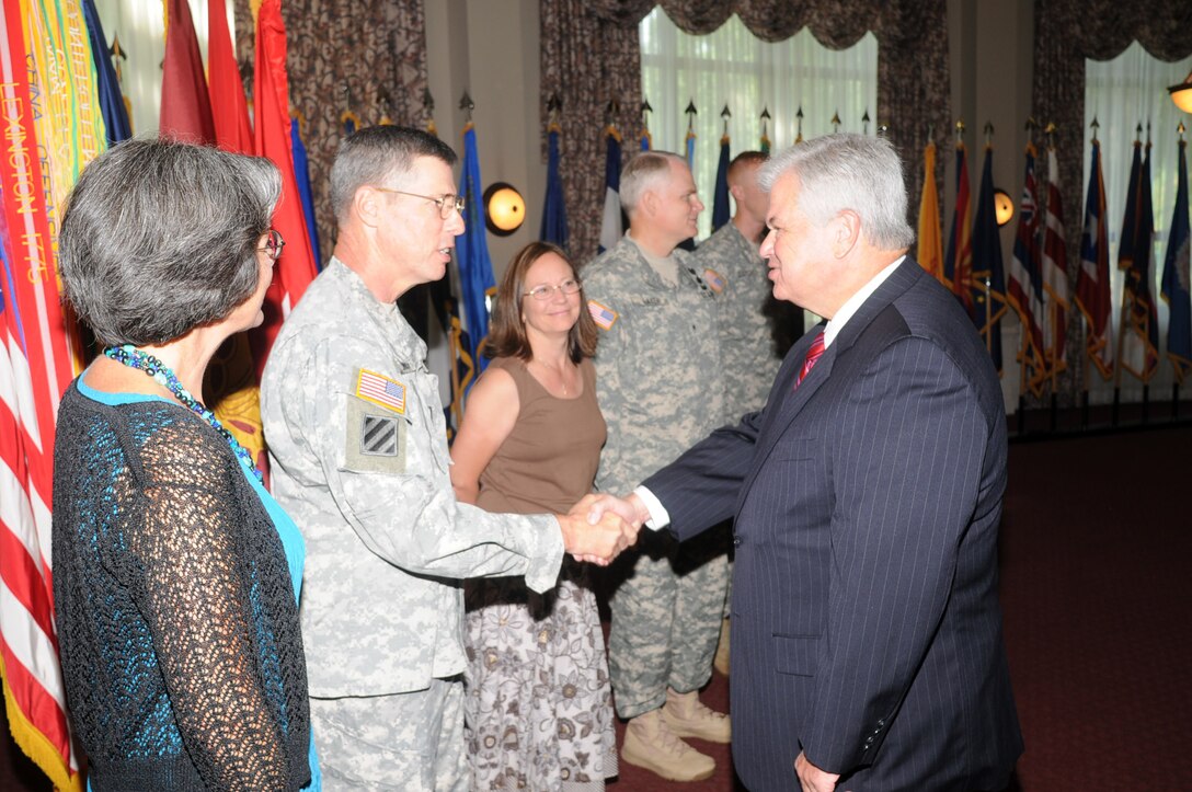 Lt. Gen. John E. Sterling Jr., Deputy Commanding General and Chief of Staff of Training and Doctrine Command, his wife Cathy, and Brig. Gen. Brian R. Layer, Commanding General and Chief of Transportation, and his wife Ella, are greeted by Joe Frank, former city of Newport News mayor, during a senior mission commander transfer of responsibility reception at the Fort Eustis Club Tuesday.