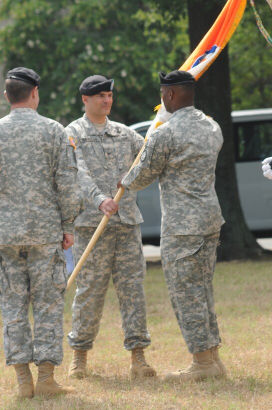 Col. Todd Isaacson, 93rd Signal Brigade incoming commander, returns the unit guidon to Command Sgt. Maj. Joseph J. McKinnon, 93rd Sig. Bde. command sergeant major, after receiving the guidon from Brig. Gen. Jennifer L. Napper, 7th Signal Command commanding general, signifying the 93rd Sig. Bde. change of command during the 93rd Sig. Bde. change of command ceremony July 30 at Seay Plaza. 

