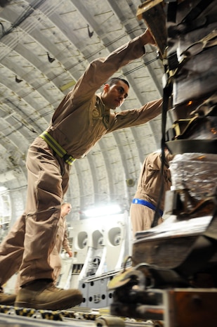 U.S. Air Force Staff Sgt. Manuel Chacon pushes a pallet of halal meals off a C-17 at Bagram Airfield, Afghanistan, Aug. 2 during a humanitarian relief mission. The meals are some of the 345,000 that have been delivered to Pakistani flood victims since July 31 to the area that?s been hard-hit by monsoon rains in recent days. Sergeant Chacon is a loadmaster from Sun Valley, Calif., and is assigned to the 817th Expeditionary Airlift Squadron at the transit center at Manas, Kyrgyzstan. He is currently deployed from the 15th Airlift Squadron at Joint Base Charleston, S.C. (U.S. Air Force photo by Capt. Chris Sukach, Regional Command-East Public Affairs)