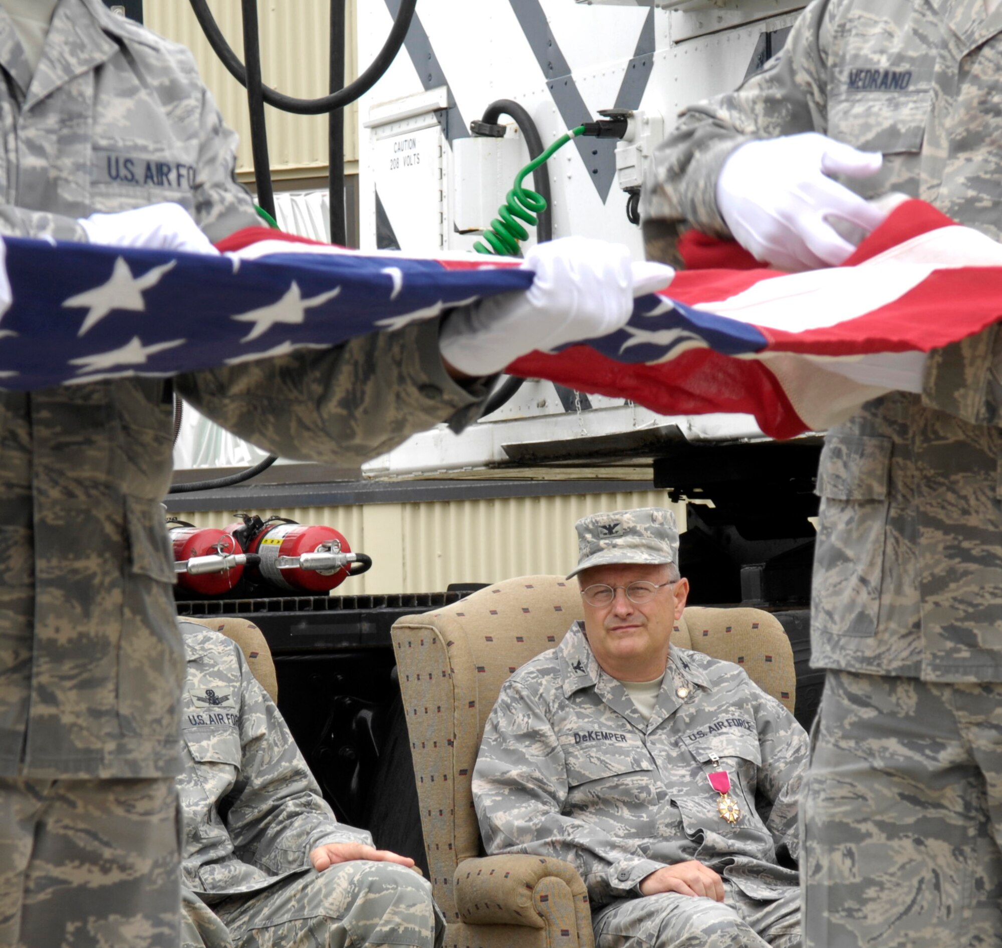 VANDENBERG AIR FORCE BASE, Calif. - Col. Carl DeKemper, the former 576th Flight Test Squadron commander, watches a flag folding presentation during his ceremony here Tuesday, Aug. 3, 2010. The 576th FLTS’s enlisted leadership performed the flag folding ceremony in honor of Colonel Dekemper’s retirement. (U.S. Air Force photo/Airman 1st Class Lael Huss)