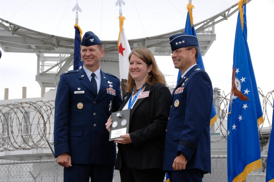 Lt. Gen. John T. Sheridan, commander of the Space and Missile Center, Air Force Space Command, Los Angeles Air Force Base, Calif., and Col. Wayne Monteith, the 50th Space Wing Commander, present Mayor Melinda Hamilton of Sunnyvale, Calif., with a commemorative plaque during a closure ceremony for Onizuka Air Force Station, July 28, 2010. Built in 1960, Onizuka AFS was originally known as the Air Force Satellite Test Center. It was selected for closure by the Base Closure and Realignment Commission in 2005, with the recommendation to move operations to Vandenberg Air Force Base, in order to consolidate satellite command and control operations while reducing excess infrastructure. (Air National Guard photo by Master Sgt. Dan Kacir)