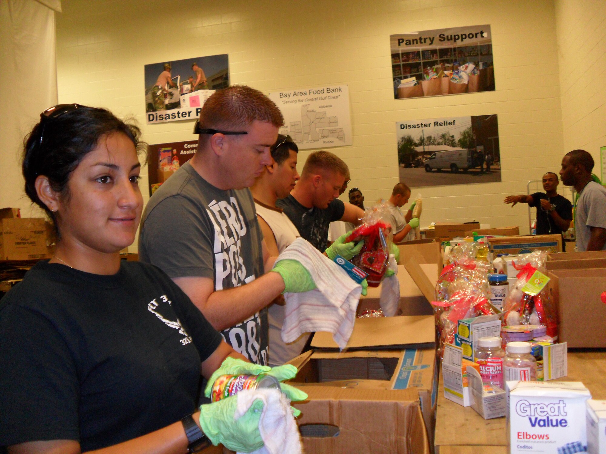 From left, Airman Grace Alva, Staff Sgt. Steven Pflug and Senior Airmen Jon Talley and Staltyn Murillo were among the 38 Airmen from the 335th Training Squadron who volunteered at the Bay Area Food Bank in Theodore, Ala., Saturday.  The volunteers sorted more than 10,000 pounds of food and boxed groceries for 540 families, according to Staff Sgt. Amber Shema, who organized the effort.  The food bank, which serves the residents of the central Gulf of Mexico states of Alabama, Florida and Mississippi, is facing the challenge of helping many families in the area who’ve lost their incomes because of the BP oil spill.  The food bank is part of Feeding America, the nation’s leading domestic hunger relief network.  (U.S. Air Force photo by Staff Sgt. Amber Shema)