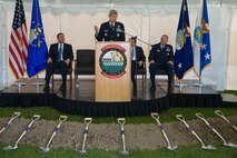Gen. Norton A. Schwartz, Air Force chief of staff, speaks to the attendees of the groundbreaking ceremony May 1, 2010 for the new Fisher House and meditation pavilion for the families of the fallen at Dover Air Force Base, Delaware, along with Michael B. Donley, secretary of the Air Force, Kenneth Fisher, Fisher House Foundation chairman, and Col. Robert H. Edmondson, commander of the Air Force Mourtuary Affairs Operations Center, which provides comfort for those awaiting the return of their fallen family members from overseas. (U.S. Air Force photo/Roland Balik)