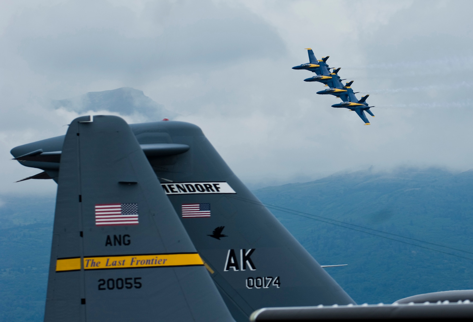 JOINT BASE ELMENDORF-RICHARDSON, Alaska -- A four-plane formation of Boeing F/A-18 Hornets from the U.S. Navy  Blue Angels make their way around to center stage during  their performance at Joint Base Elmendorf-Richardson's Arctic Thunder Aug. 1. Arctic Thunder 2010, a two-day event featured the Navy Blue Angels and the Canadian Forces Snowbirds Demonstration Team, along with many other aerial demonstrations and static displays. (Air Force photo by Airman 1st Class Christopher Gross) 