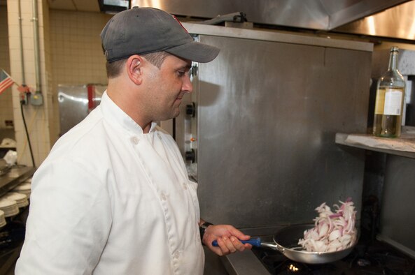 HANSCOM AIR FORCE BASE, Mass. – Chef Reid Hannula sautés an onion for one of his new entrées. The chef, who arrived at Hanscom in June, has renovated the menus at the Minute Man Club. (U.S. Air Force photo by Rick Berry)