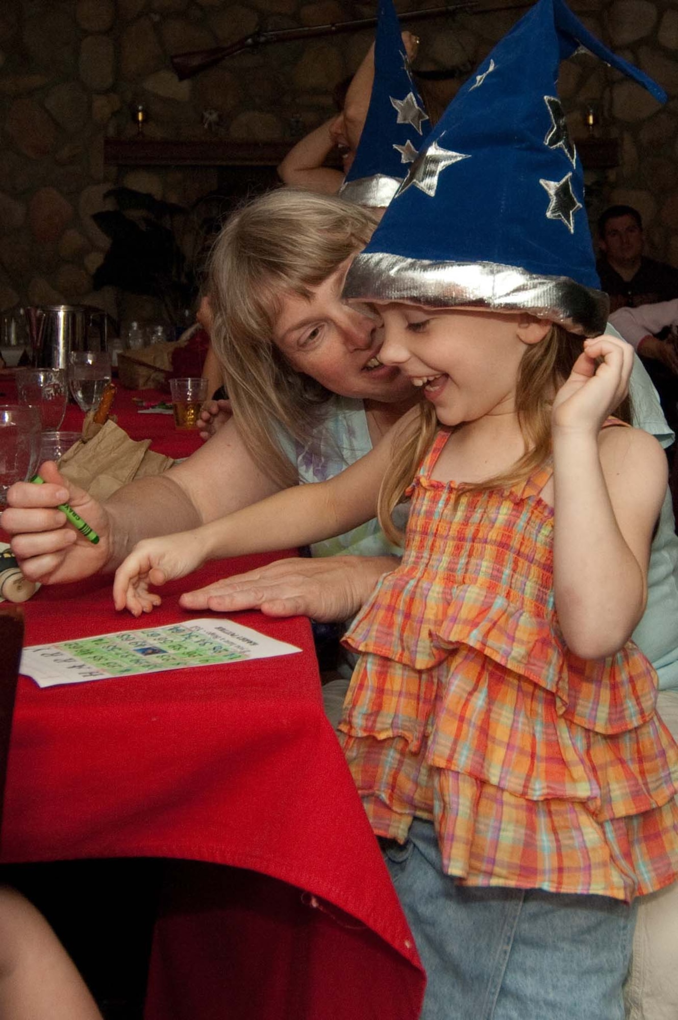 HANSCOM AIR FORCE BASE, Mass. – Gryffindor House member Elizabeth Kalinowsky uses her magic skills to win a round of Harry Potter Bingo. The game was one of several activities following the feast at Saturday’s Harry Potter banquet. (U.S. Air Force photo by Rick Berry)