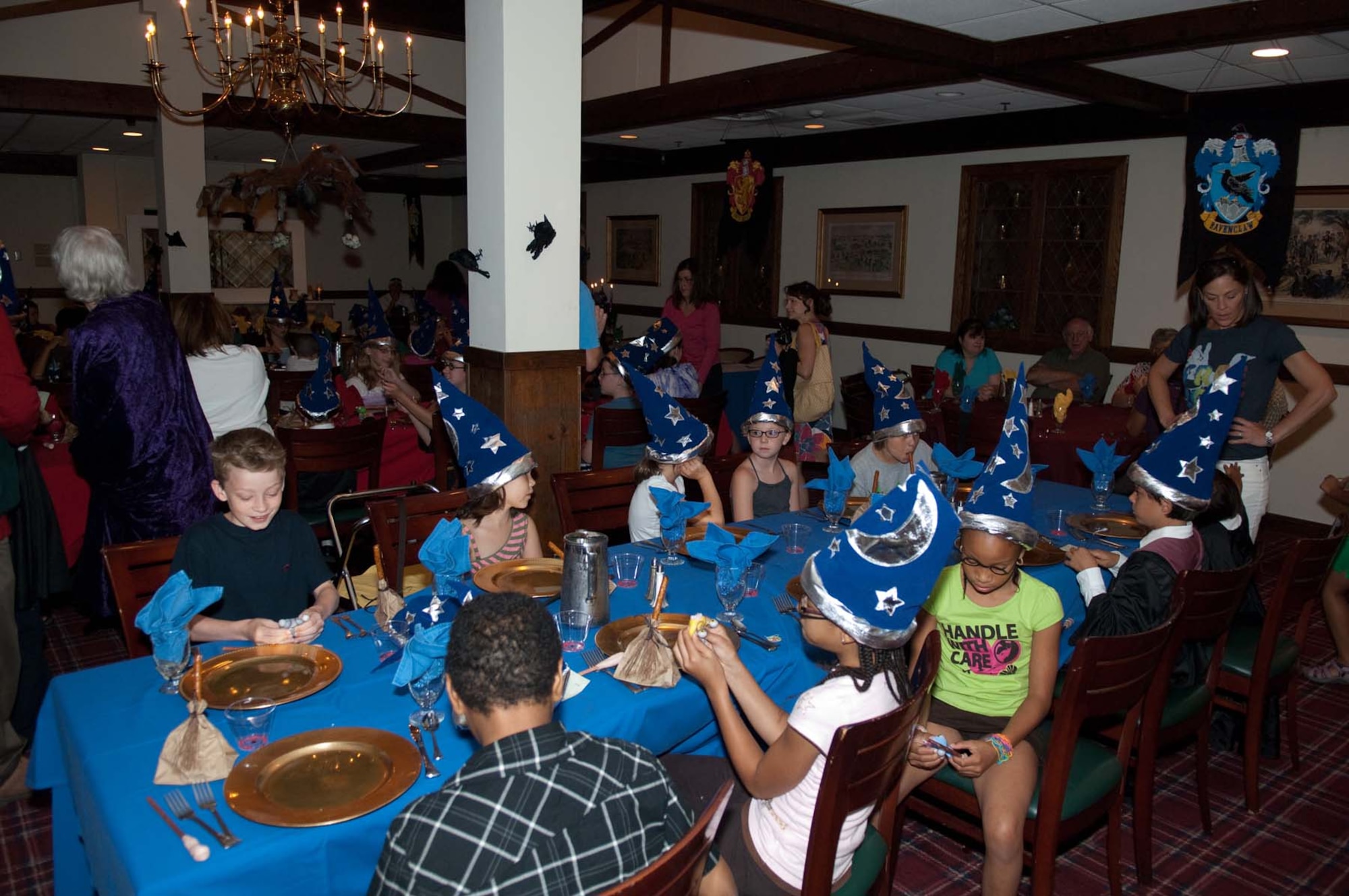 HANSCOM AIR FORCE BASE, Mass. – Members of Ravenclaw, one of the four Houses of Hogwarts, sit down to a magical meal. For the Harry Potter themed feast, the club conjured up a buffet including Hogwarts Roast Beef, Flitwick's French Fries and Honeyduke’s Sweets. (U.S. Air Force photo by Rick Berry)