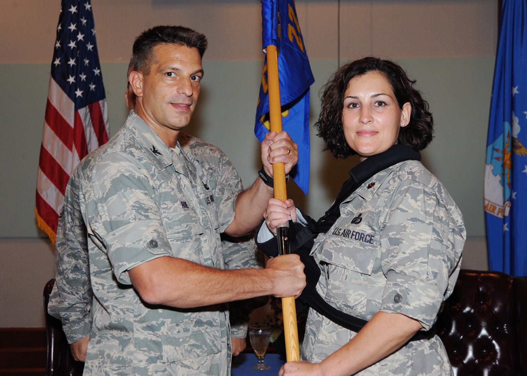 Col. Pat Rose, 22nd Mission Support Group commander passes the guidon to Maj. Amy S. Harshner, 22nd Contracting Squadron commander, during a change of command ceremony July 29, 2010, McConnell Air Force Base, Kan.  The passing of the guidon symbolizes Major Harshner assuming command.  The 22nd CS provides acquisition support, enabling Team McConnell to maintain combat readiness and sustainability worldwide.  (U.S. Air Force photo/Airman 1st Class Andrea Salazar)