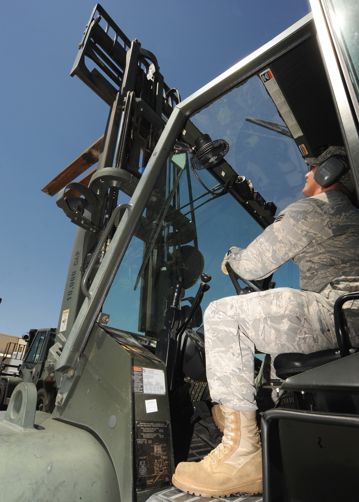 Staff Sgt. Michael Glaser, 22nd Logistics Readiness Squadron vehicle operator/dispatcher, inspects the moving parts of a 10,000 pound capacity forklift Aug. 3, 2010, McConnell Air Force Base, Kan.  The vehicles are inspected after a customer returns it and on a daily basis to ensure operational and safety standards are met.  The vehicle operations unit currently has vehicles available for loan out to personnel for official travel during temporary duty orders at McConnell. The unit currently has a fleet of 63 vehicles valued at $2.4 million.  (U.S. Air Force photo/Senior Airman Maria Ruiz)