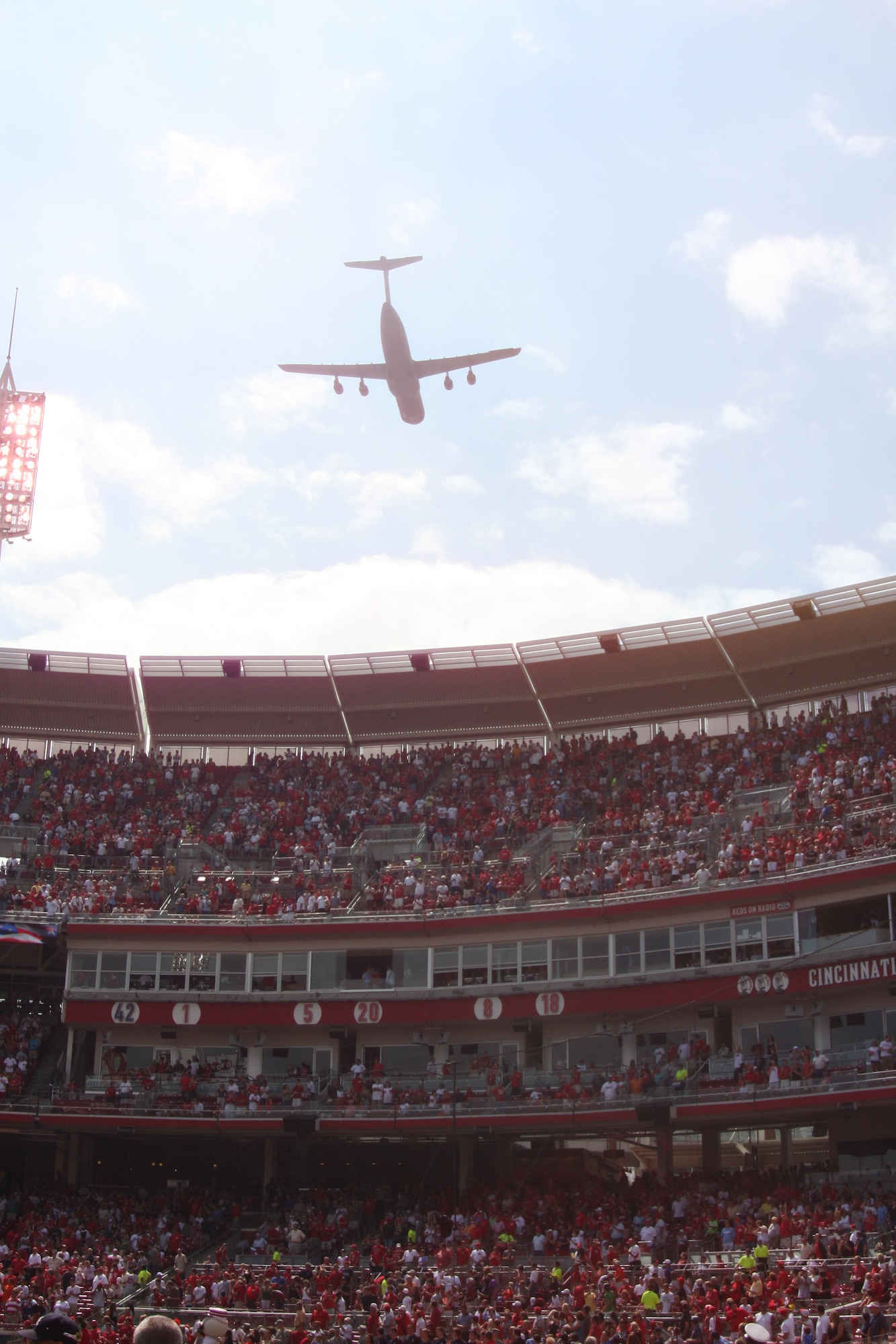 WRIGHT-PATTERSON AIR FORCE BASE, Ohio – A 445th Airlift Wing C-5 Galaxy performed a flyover at the Great American Ball Park July 31 during the Cincinnati Reds pre-game ceremony.  Tech. Sgt. Joe Heitzenrater, 445th Civil Engineer Squadron, and three other Airmen and their families were recognized during the ceremony as part of Wright-Patterson Air Base Military Appreciation Day. (U.S. Air Force photo/Staff Sgt. Robert Nelson)