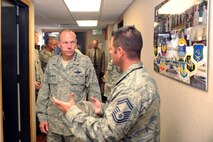 MINOT AIR FORCE BASE, N.D. -- General Donald Hoffman, Air Force Materiel Command commander, is given a tour by Senior Master Sgt. Wayne Jones, 17th Munitions Squadron flight chief, here Aug. 3. General Hoffman visited Minot to ensure the 798th Munitions Maintenance Group and 17th MUNS have the tools necessary to complete their unique missions. (U.S. Air Force photo by Airman 1st Class Aaron-Forrest Wainwright)