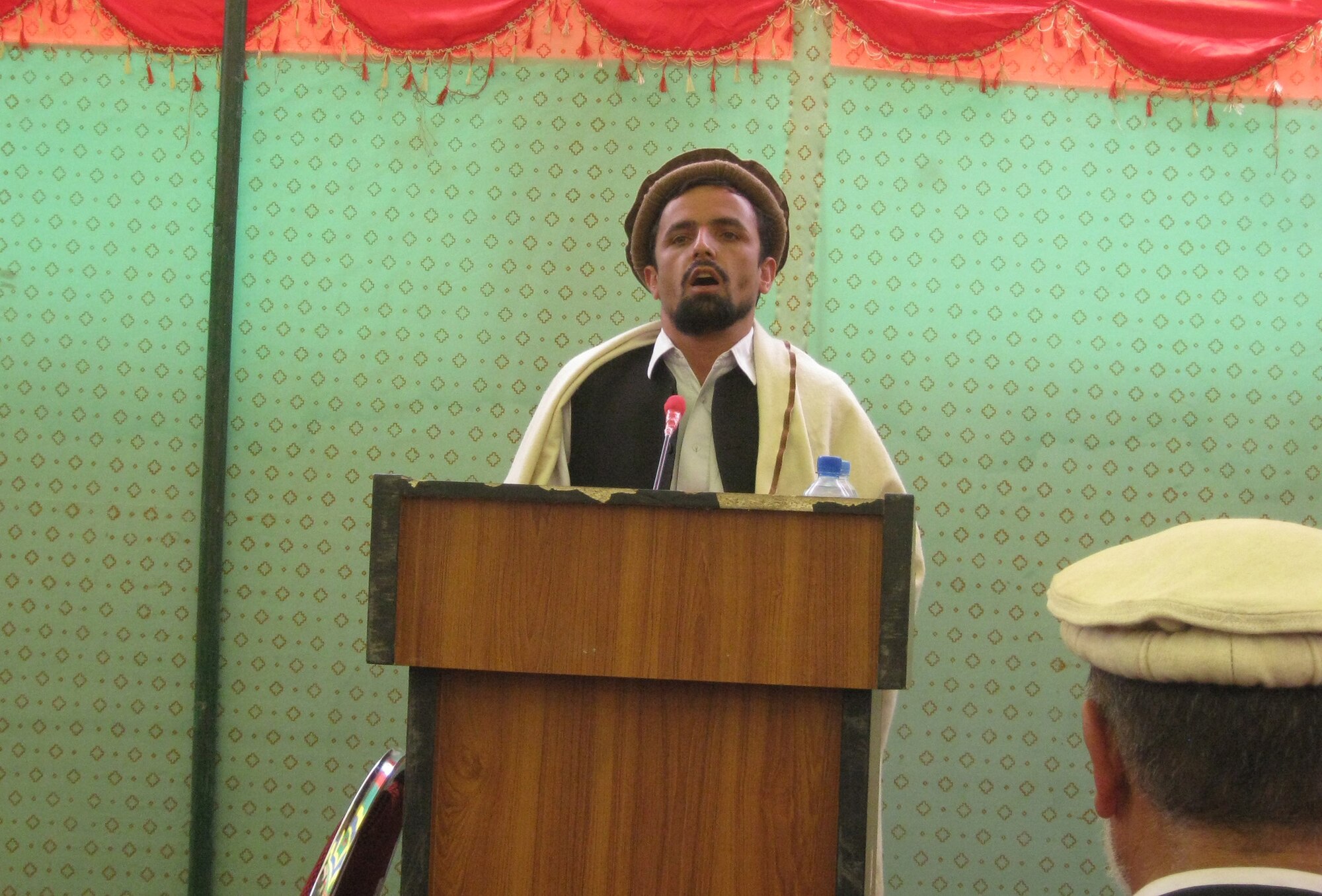 Sen. Mawllawe Mohammad Faizi, Afghanistan House of Elders member, addresses the crowd during the ribbon-cutting ceremony for the Paryan Justice Center Aug. 2. Panjshir Deputy Gov. Abdul Rahman Kabiri, senators, various district governors, Provincial Reconstruction Team Panjshir members and Afghan journalists were among those on hand to witness the ceremony. (Photo by U.S. Air Force 2nd Lt. Jason Smith, PRT Panjshir Public Affairs)