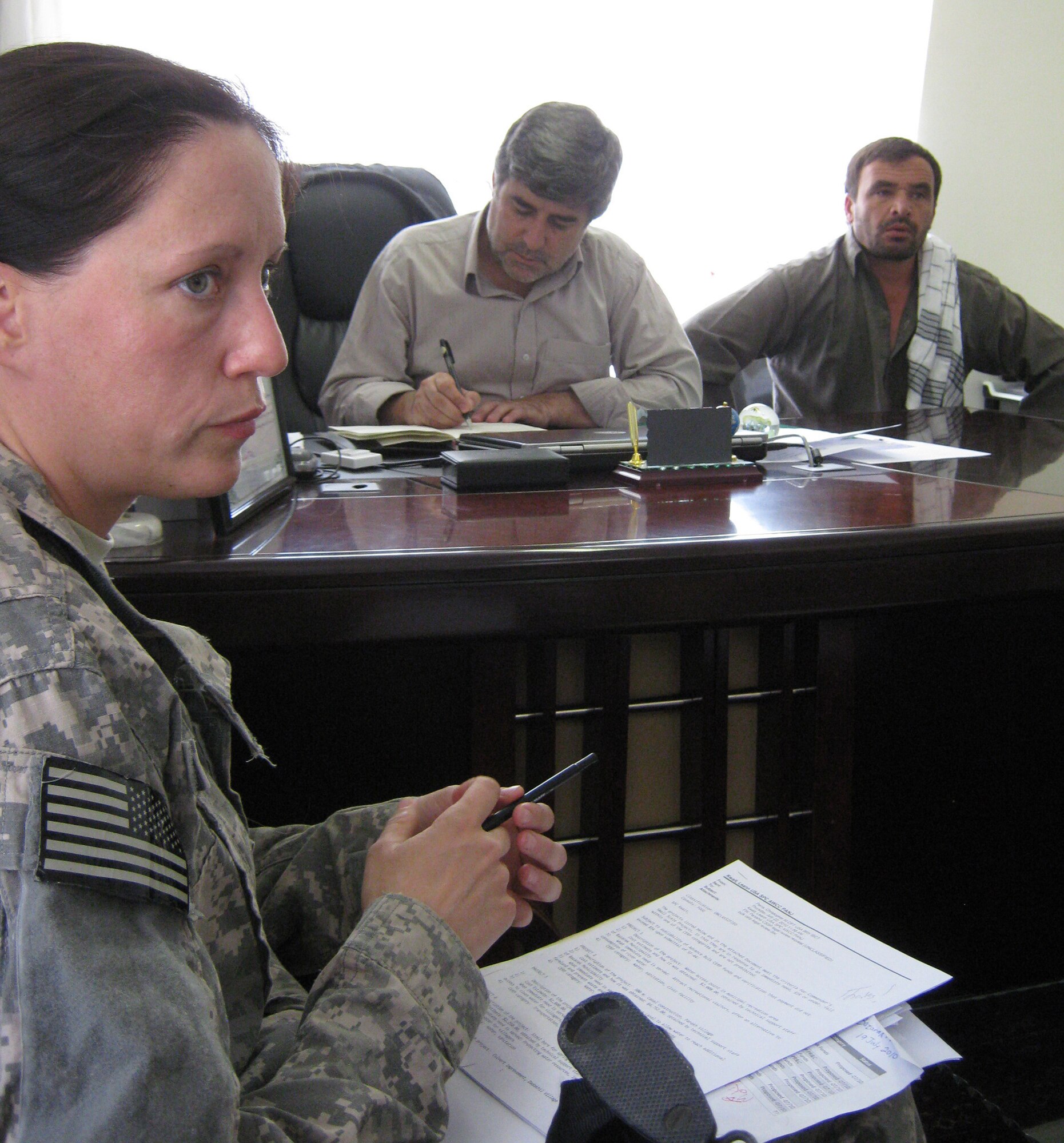 U.S. Army Spc. LeAnn Kwait, Provincial Reconstruction Team Panjshir Civil Affairs and Levittown, Pa., native, talks about commander-approved projects during a weekly regional Community Development Council meeting at the Bazarak Mayor?s Office July 26. (Photo by U.S. Air Force 2nd Lt. Jason Smith, PRT Panjshir Public Affairs)