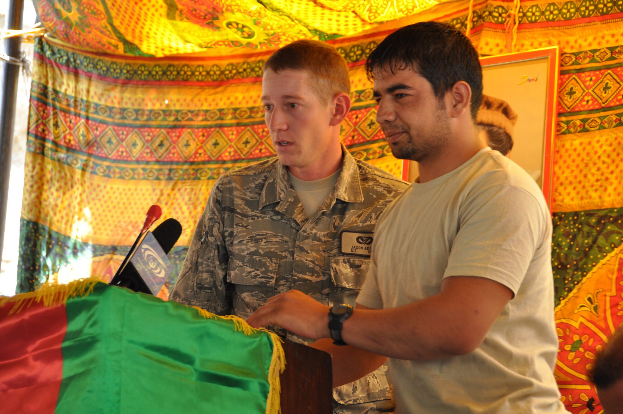 First Lt. Jason Adams, Provincial Reconstruction Team Panjshir civil engineer, gives a speech during a ribbon-cutting ceremony in the Paryan District of the Panjshir Province, Afghanistan. The group formally opened construction July 19 on Section 3.5 of the only main road running through the valley. (Photo by U.S. Air Force 1st Lt. Holly A. Hess, PRT Panjshir Public Affairs Photographer)