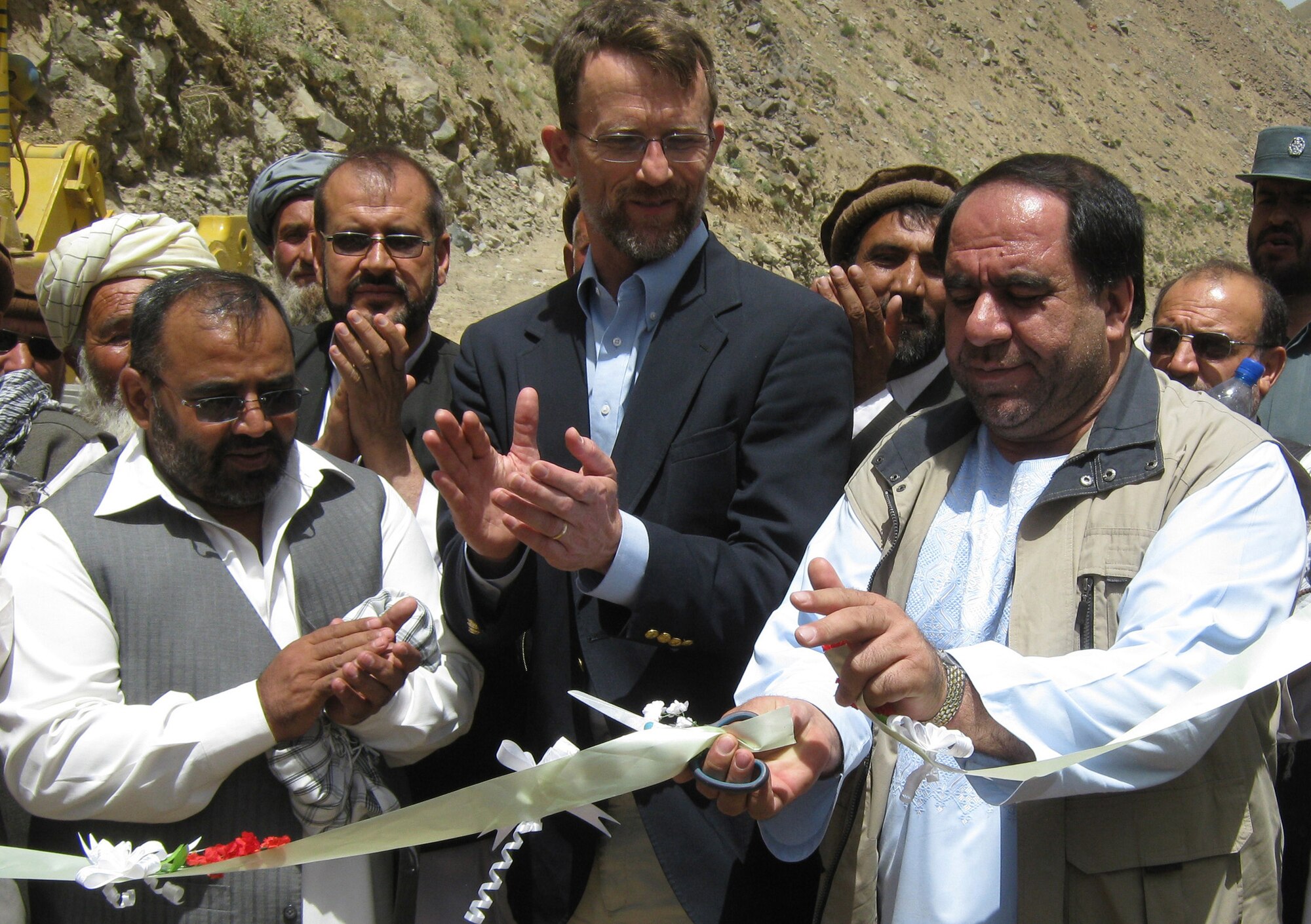 (left to right) Panjshir Provincial Deputy Gov. Abdul Rahman Kabiri, Bill Martin, U.S. Department of State and Provincial Reconstruction Team Panjshir director, and Panjshir Gov. Keramuddin Keram, participate in a ribbon-cutting ceremony in the Paryan District of the Panjshir Province, Afghanistan. The group formally opened construction July 19 on Section 3.5 of the only main road running through the valley. (Photo by U.S. Air Force 2nd Lt. Jason Smith, PRT Panjshir Public Affairs)