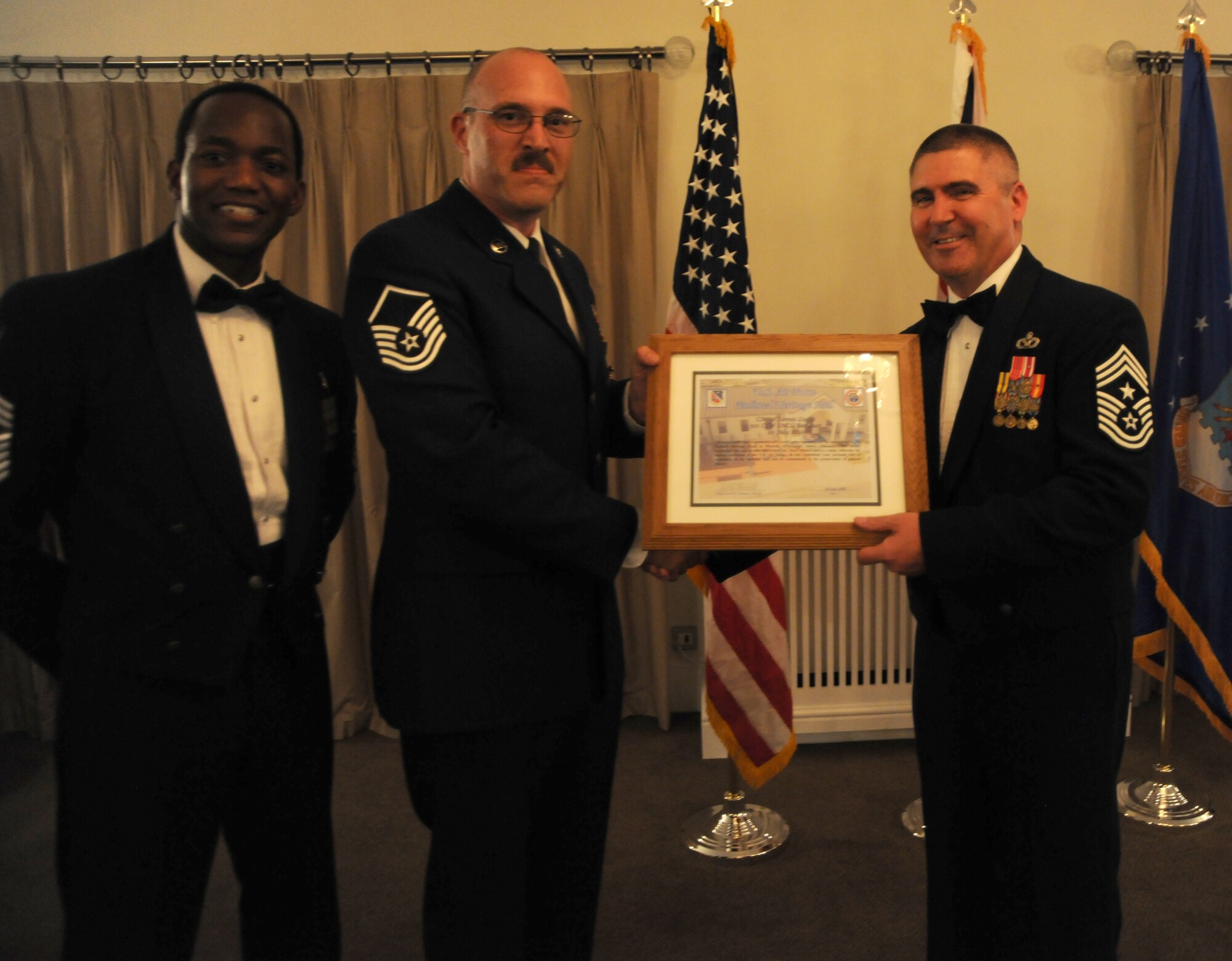 RAF ALCONBURY, United Kingdom - Command Chief Master Sgt. James Lucas (right), 48th Fighter Wing, is thanked by the 501st Combat Support Wing for being the guest speaker during the Senior NCO Induction Ceremony July 30 here. (U.S. Air Force Photo by Staff Sgt. Joel Mease)
