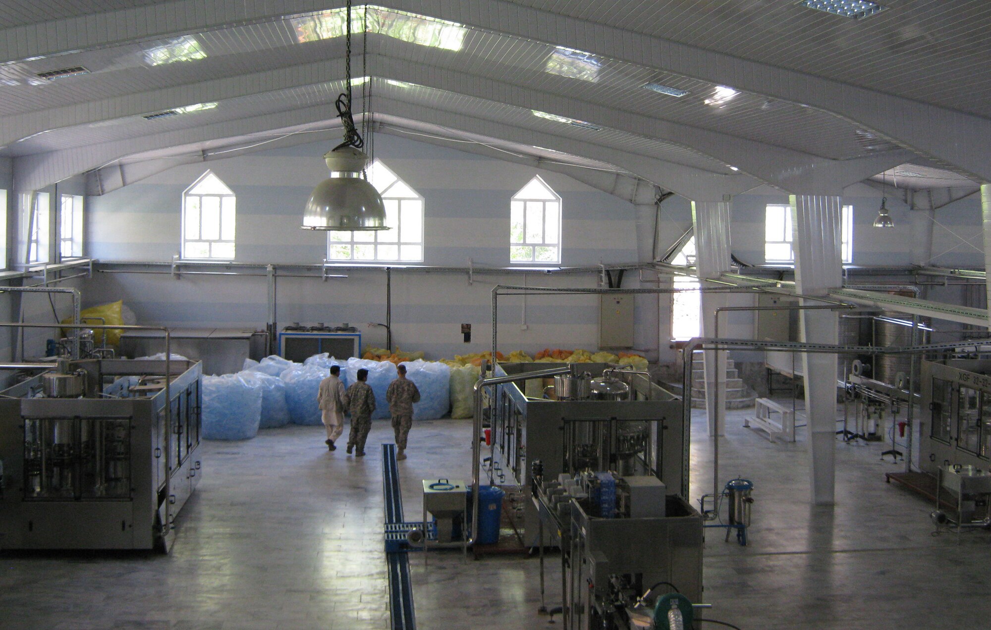 Members of Provincial Reconstruction Team Panjshir and Army Chief Warrant Officer Peter Johnson, 72nd Medical Detachment Veterinary Services, toured the Panjshir Beverage Industry LTD water bottling plant in the Khenj District on July 11. Johnson conducted a pre-audit on the facility. The pre-audit is one step in approving the water for government procurement. (Photo by U.S. Air Force 2nd Lt. Jason Smith, PRT Panjshir Public Affairs)