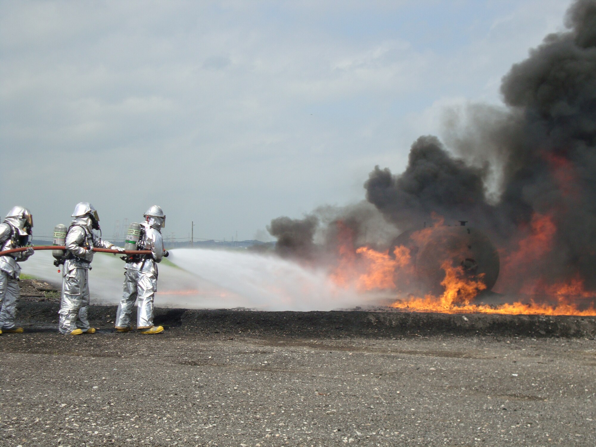 Firefighters from Osan's 51st Civil Engineer Squadron participate in joint live fire training at Camp Humphreys July 20. (U.S. Air Force photo/Master Sgt. Kevin Walker)