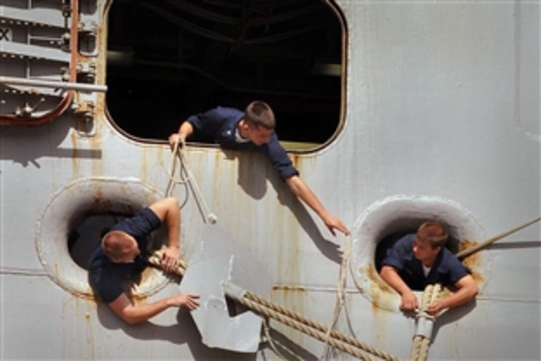 U.S. Navy sailors aboard the amphibious assault ship USS Iwo Jima apply rat guards to mooring lines as the ship arrives for refueling and supplies at Naval Station Guantanamo Bay, Cuba, Aug. 4, 2010. The Iwo Jima recently completed its first phase of the Continuing Promise 2010 humanitarian assistance operation by conducting community service projects in Haiti. Continuing Promise is a four-month humanitarian and civic assistance mission in Latin America and the Caribbean.