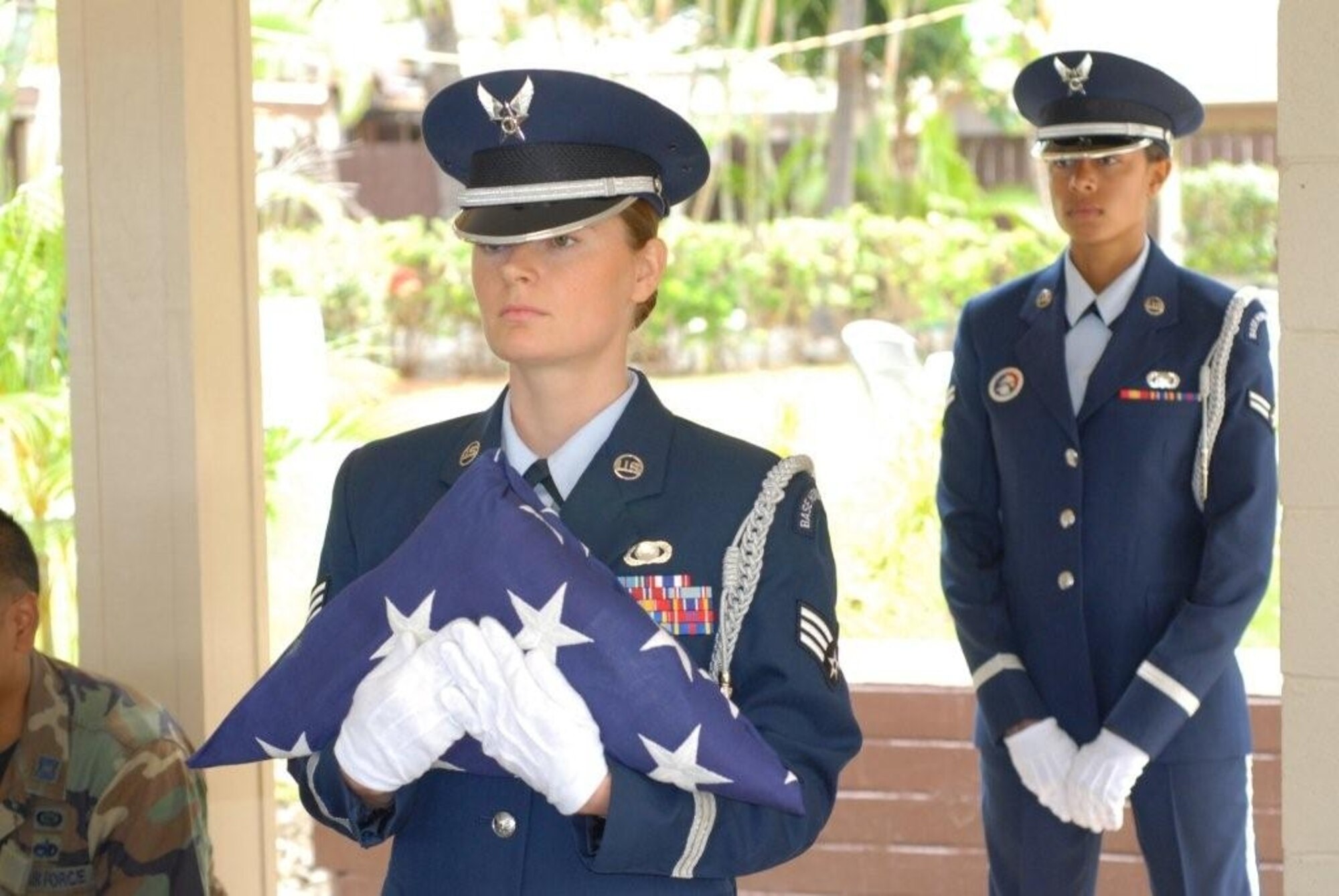Then Senior Airman Cheryl Moore, 8th Intelligence Squadron, retires a flag during an honor guard event at Joint Base Pearl Harbor Hickam, Hawaii. (Courtesy photo)