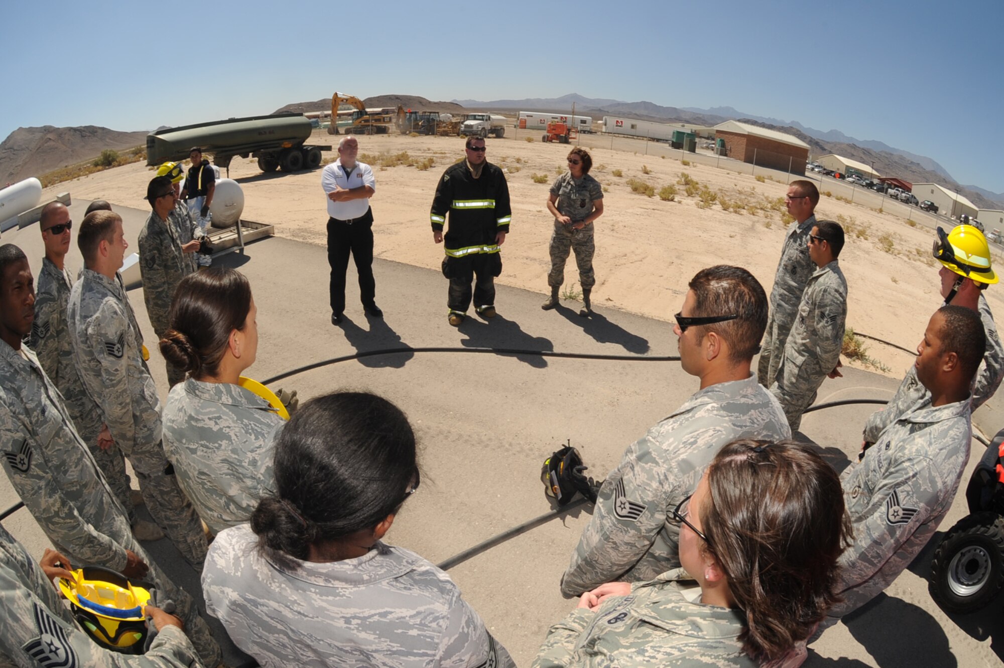 Capt. Brad Myers, a fire fighter at Creech Air Force Base, gives a briefing during the inaugural fire fighting training course held at Creech Aug. 7. The Creech fire department trained members of the 99th GCTS on basic fire fighting skills to help contain fires at the security forces training site, Silver Flag Alpha. (U.S. Air Force photo by Senior Airman Brian Ybarbo)