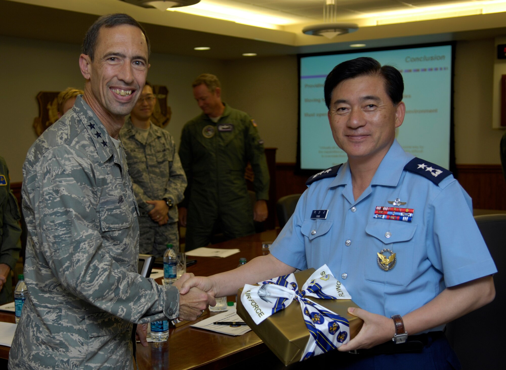 VANDENBERG AIR FORCE BASE, Calif. – Lt. Gen. Larry James, the 14th Air Force commander, gives a gift to Korean Air Force Maj. Gen. Sin-Kyu Park, after visiting here Thursday, Aug. 5, 2010. General Park and his interpreter, Korean Air Force Lt. Col. Hak Chang Kim, came to see the Joint Space Operations Center, Space Launch Complex-6 and to learn about the Joint Functional Component Command for Space. (U.S. Air Force photo/Airman 1st Class Lael Huss)