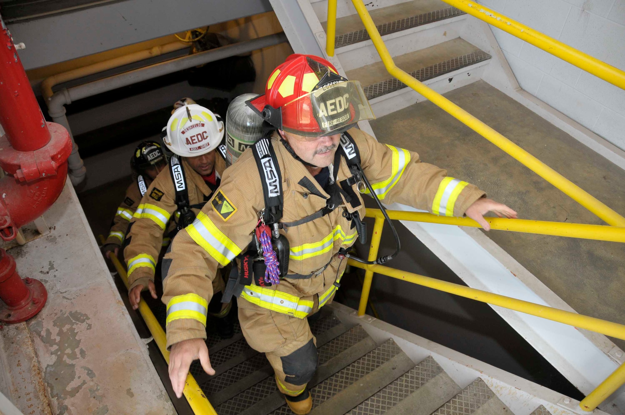 AEDC firefighters climb the steps at the Mark 1 space test facility in preparation for the Nashville Stair Climb to honor the fallen firefighters of Sept. 11, 2001. (Photo by: Rick Goodfriend)